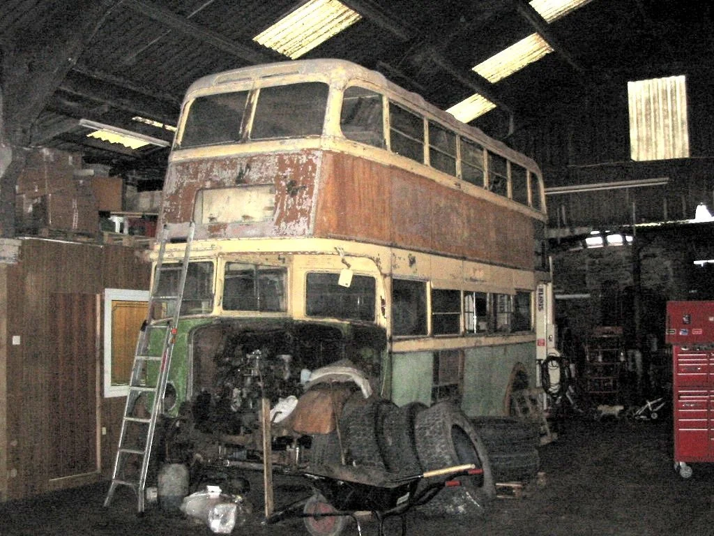 At Darton, Barnsley, surrounded by the paraphernalia of a working garage. October 2004.