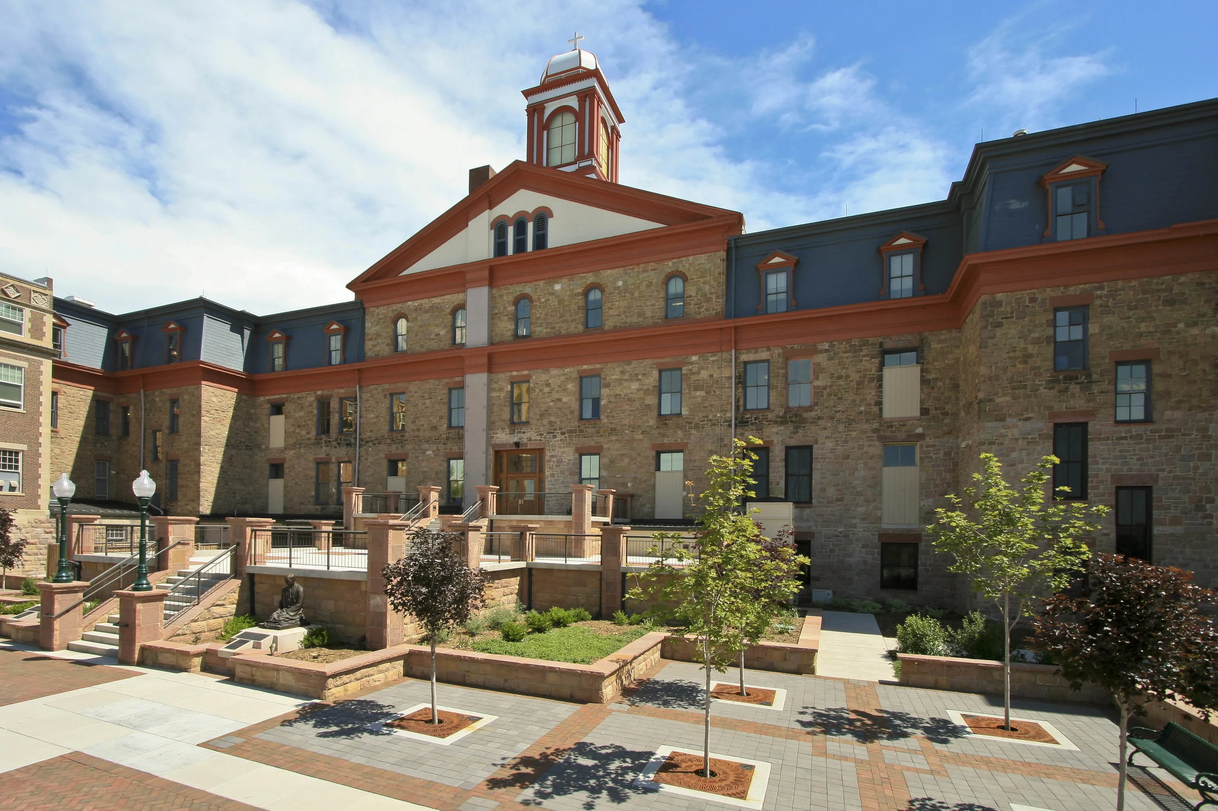 REGIS UNIVERSITY MAIN HALL - Three existing structures attached to Regis University's Main Hall (oldest building on campus originally built in 1887 were demolished and replaced with a 2-level plaza. Demolished existing site and replaced with pavers, concrete and landscaping.