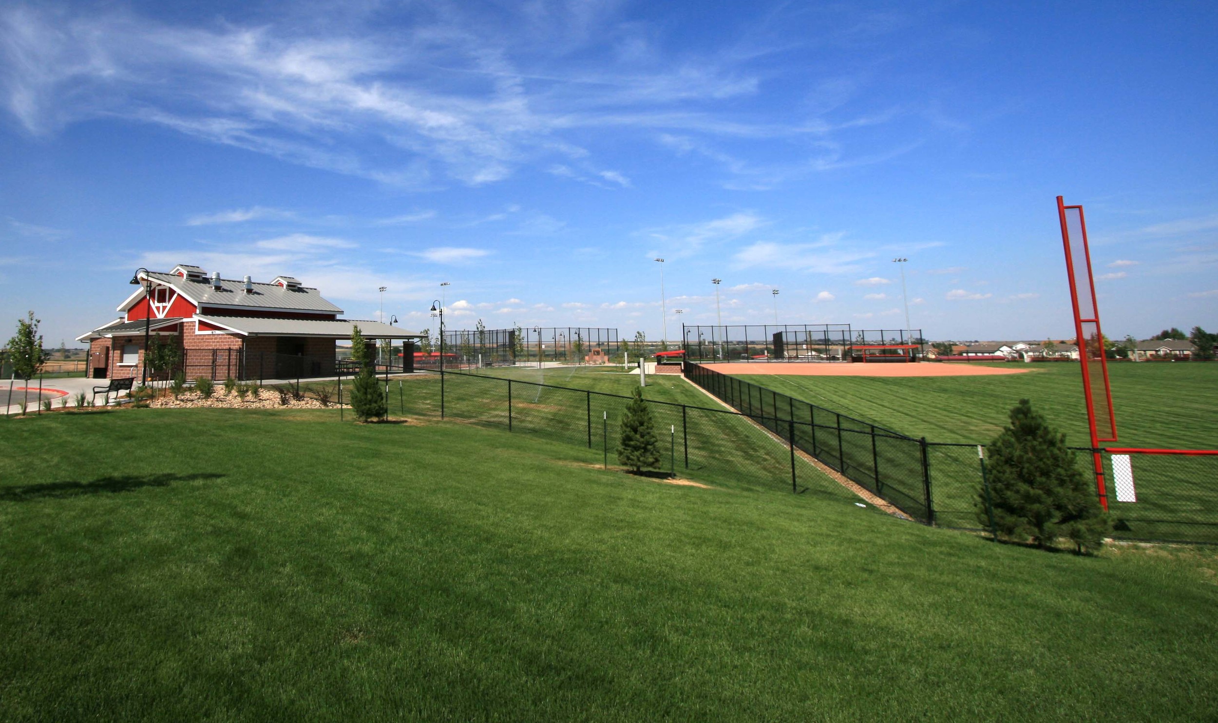 NELSON PARK BALL FIELDS - Four ball fields, a concessions/restroom building, playgrounds, concrete sidewalks, sport lighting, and 2 parking lots. Project also included landscape, raw water irrigation, site grading and drainage, and sewer and water lines.