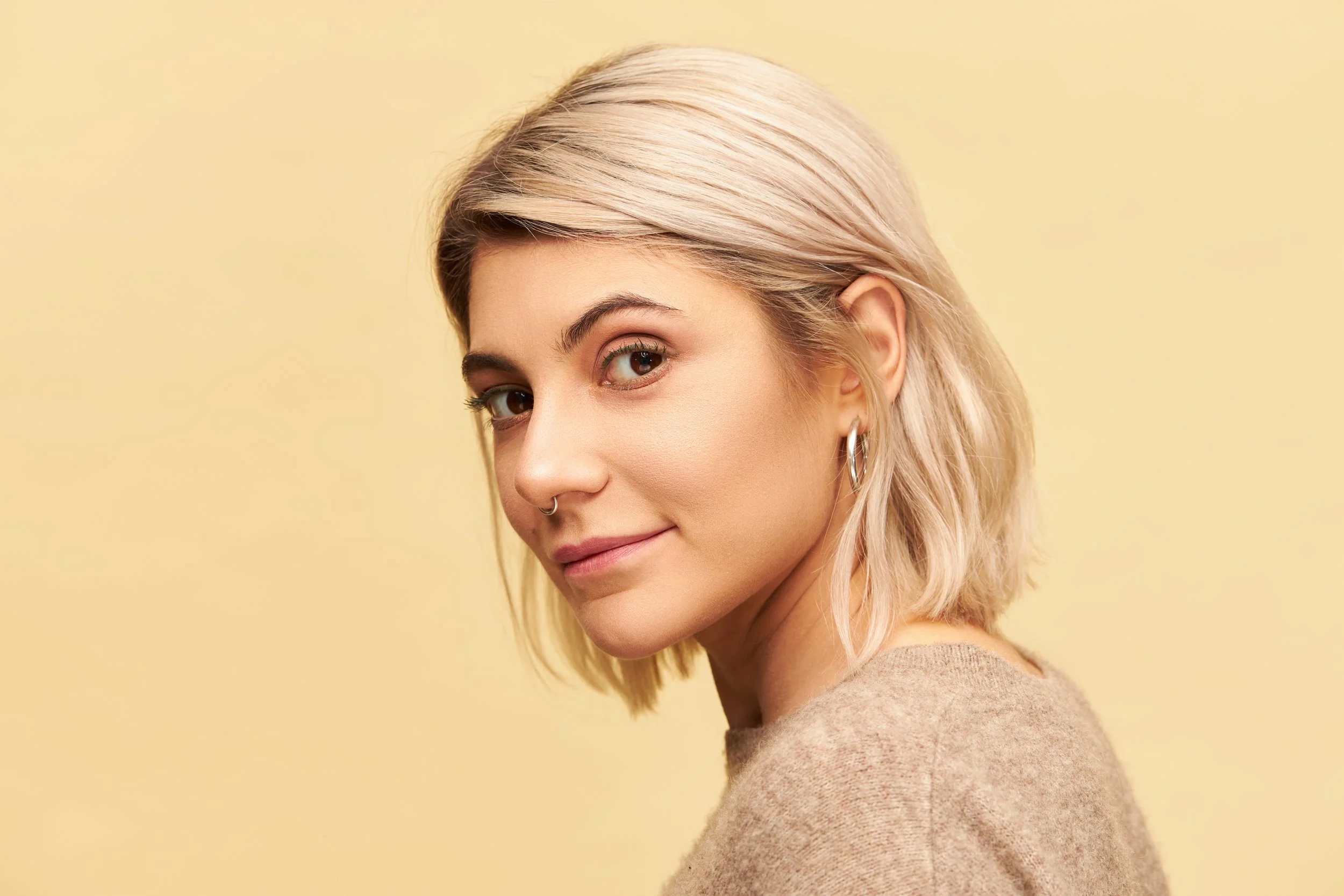 beauty-style-fashion-concept-attractive-twenty-year-old-female-with-nose-ring-dyed-bob-hair-posing-isolated-with-enigmatic-alluring-smile-dressed-cashmere-sweater.jpg