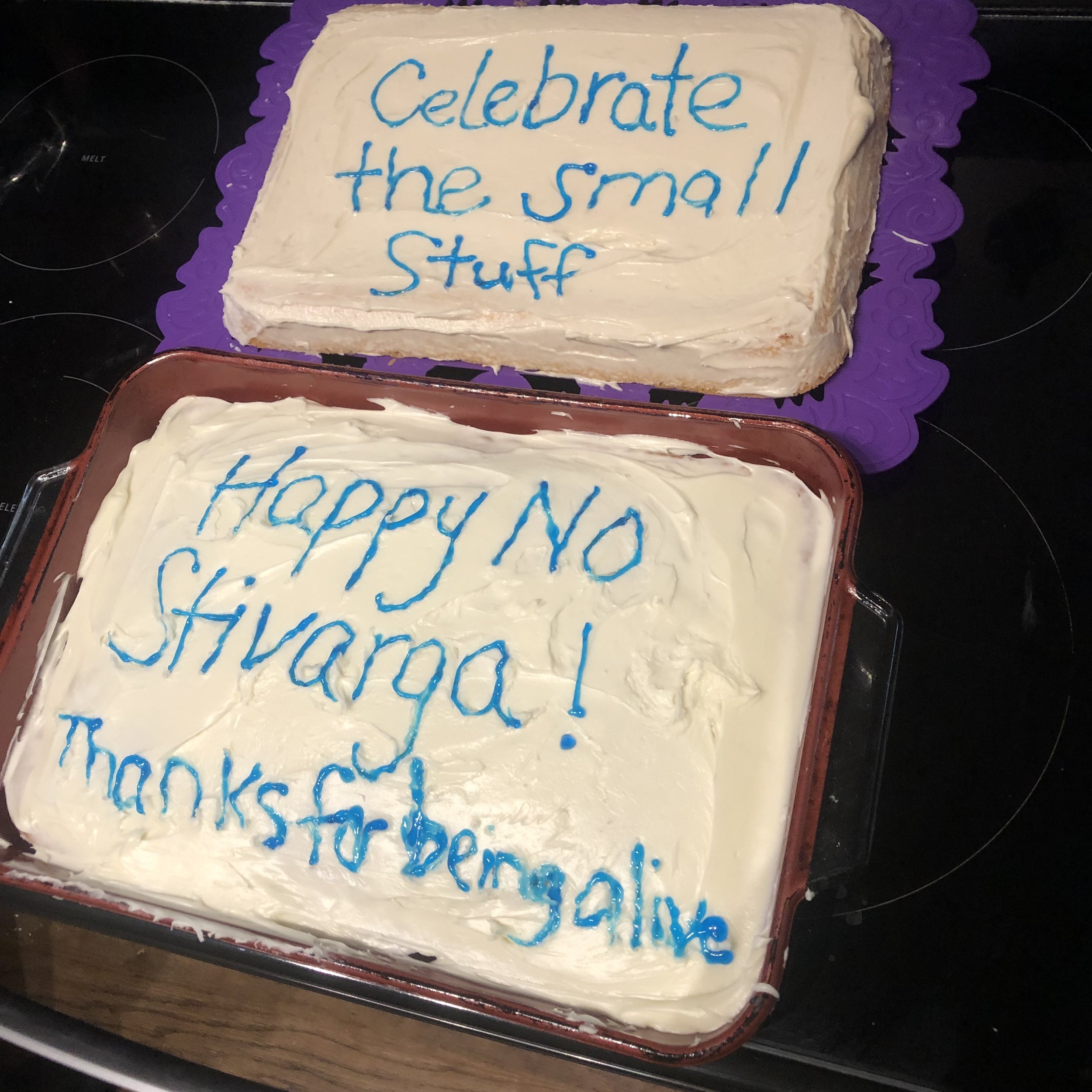 two cakes that say "celebrate the small stuff" and"happy no stivarga! Thanks for being alive"