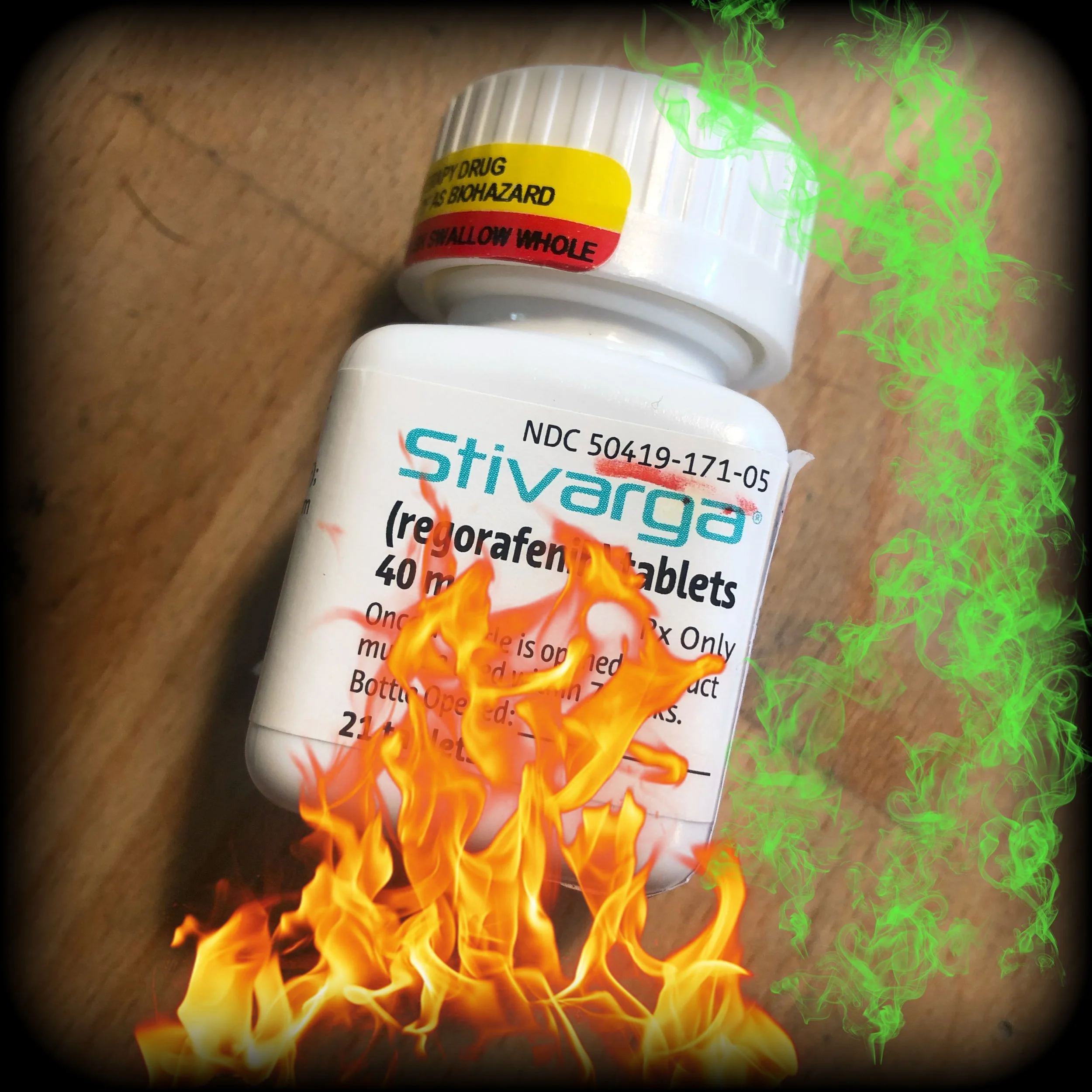empty bottle of cancer medication with fire effects laid over it