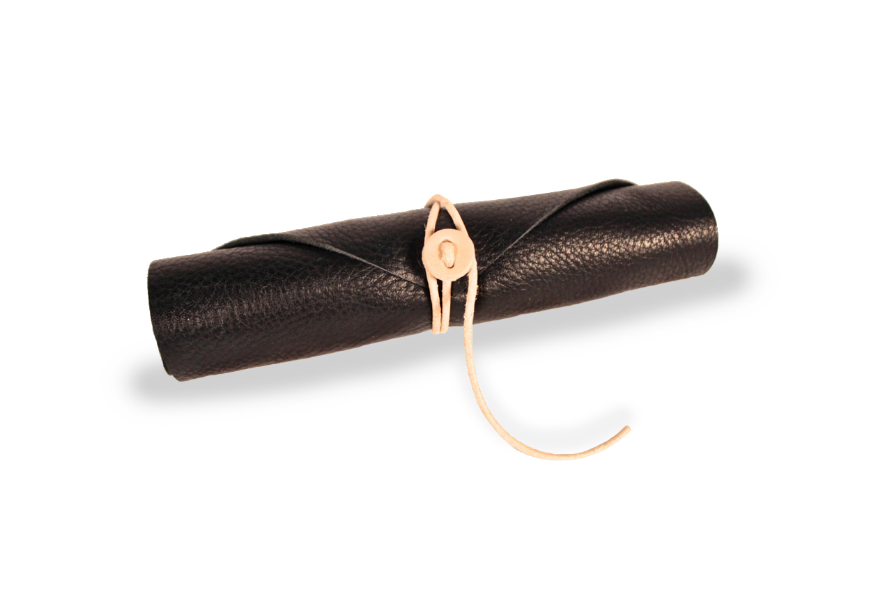 Skive packaged in a leather roll case made with supple deer tan leather and a simple cord closure.