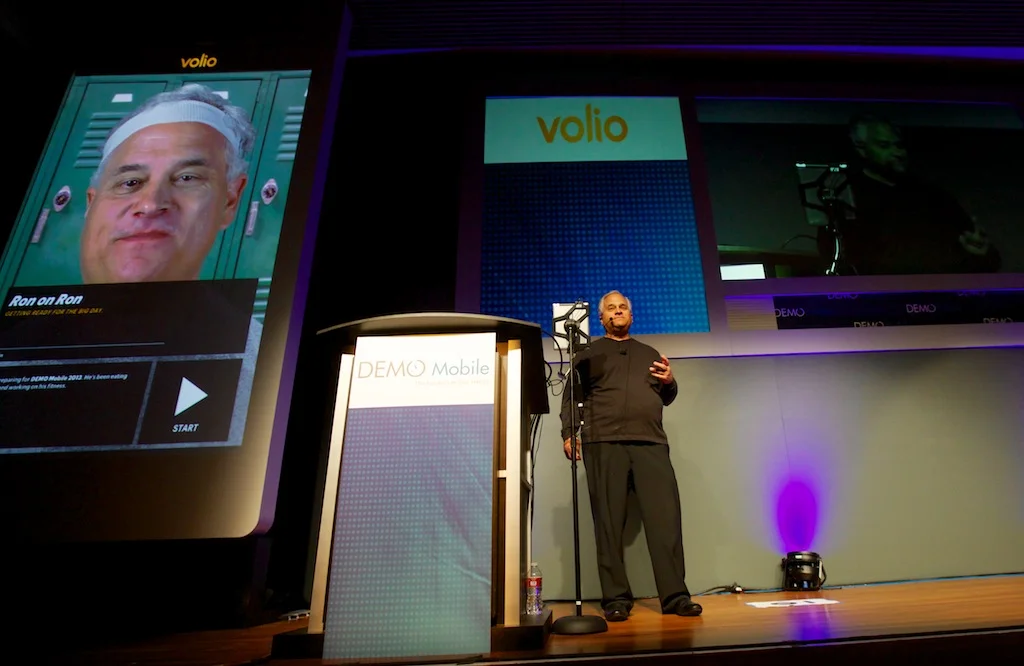 CEO Ron Croen delivering our presentation, which included a live demo of him talking to himself through our Volio application (magnified iPad on the left). I authored our award-winning presentation.