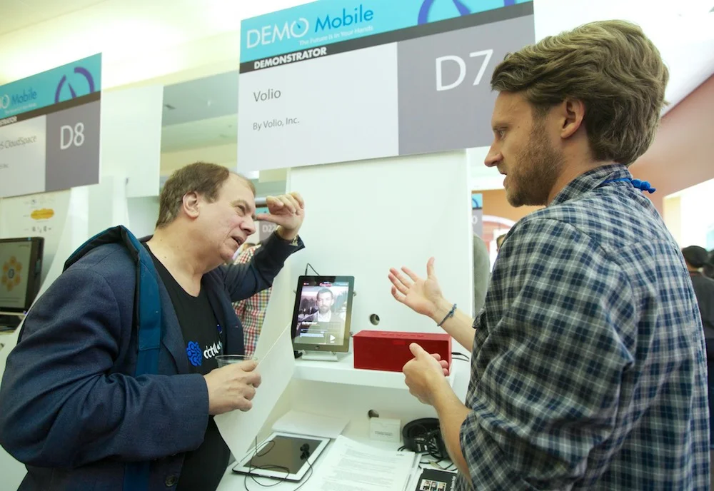 Demonstrating /explaining our product to a fellow entrepreneur at our booth following the presentation.