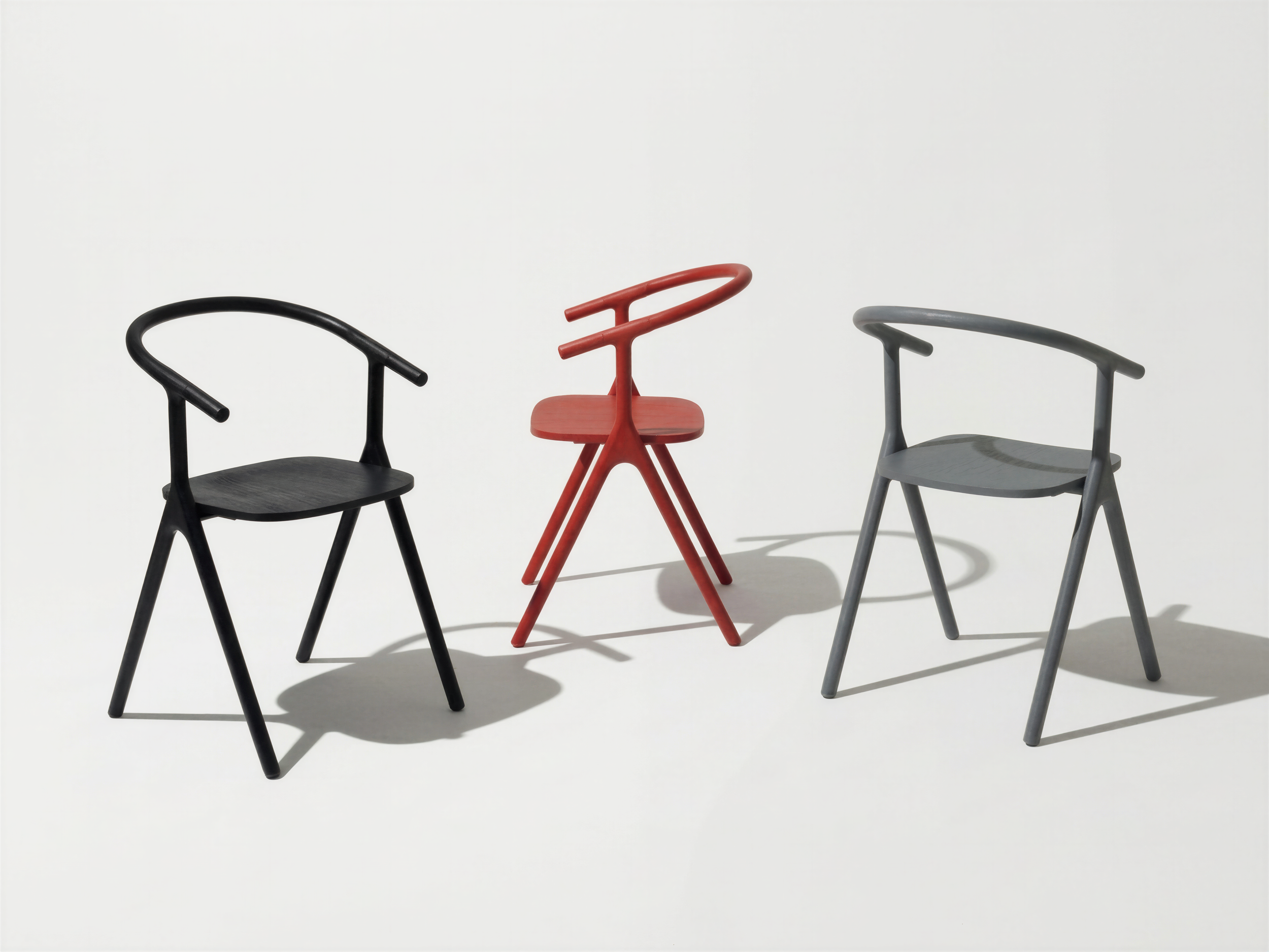 4x_create chair family portraits with chair @1 , create 3 charis in one image. use the light and clean background from @2  One chair in black, one chair in middle grey and one chair in red..png