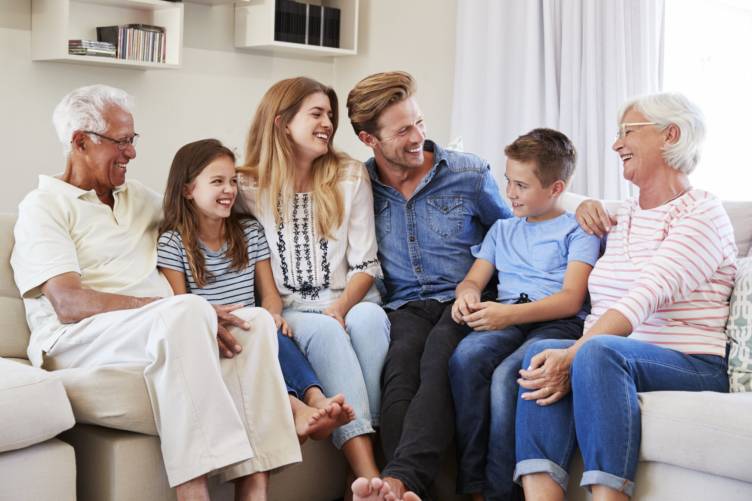 multi-generation-family-relaxing-on-sofa-at-home-P2XZ4B7.jpg