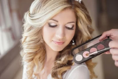46144411 - beautiful bride wedding with makeup and curly hairstyle. stylist makes make-up bride on wedding day. beauty portrait of young woman at morning.