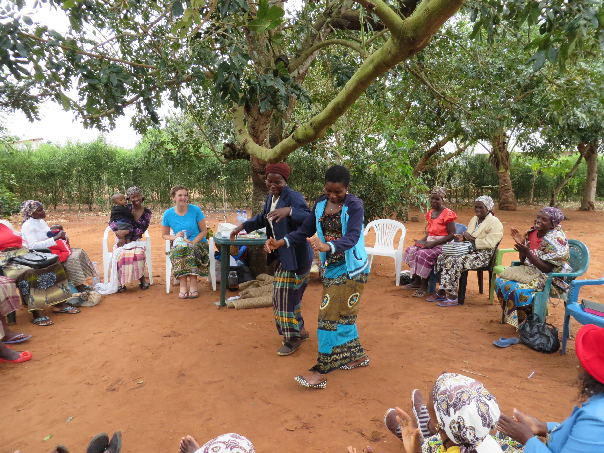 Jenn Lewis (blue shirt) and the women of Mozambique celebrate with dancing and song for the gift of hygiene kits.