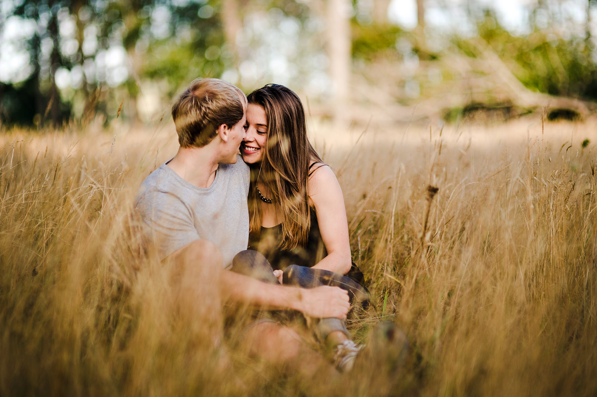 6 in love couple sitting in field of grass.jpg