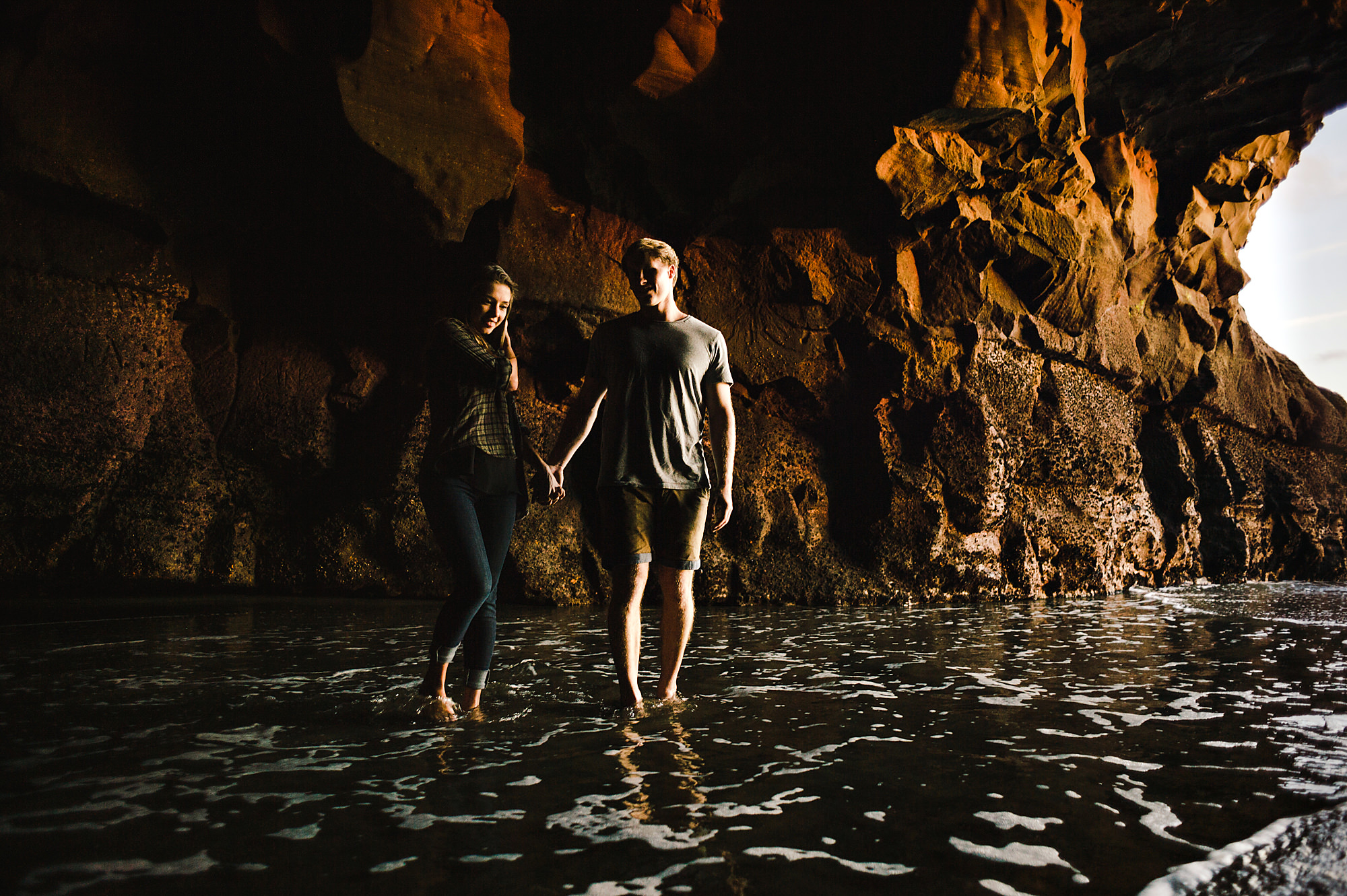13 Couple splashing in cave at sunset.jpg