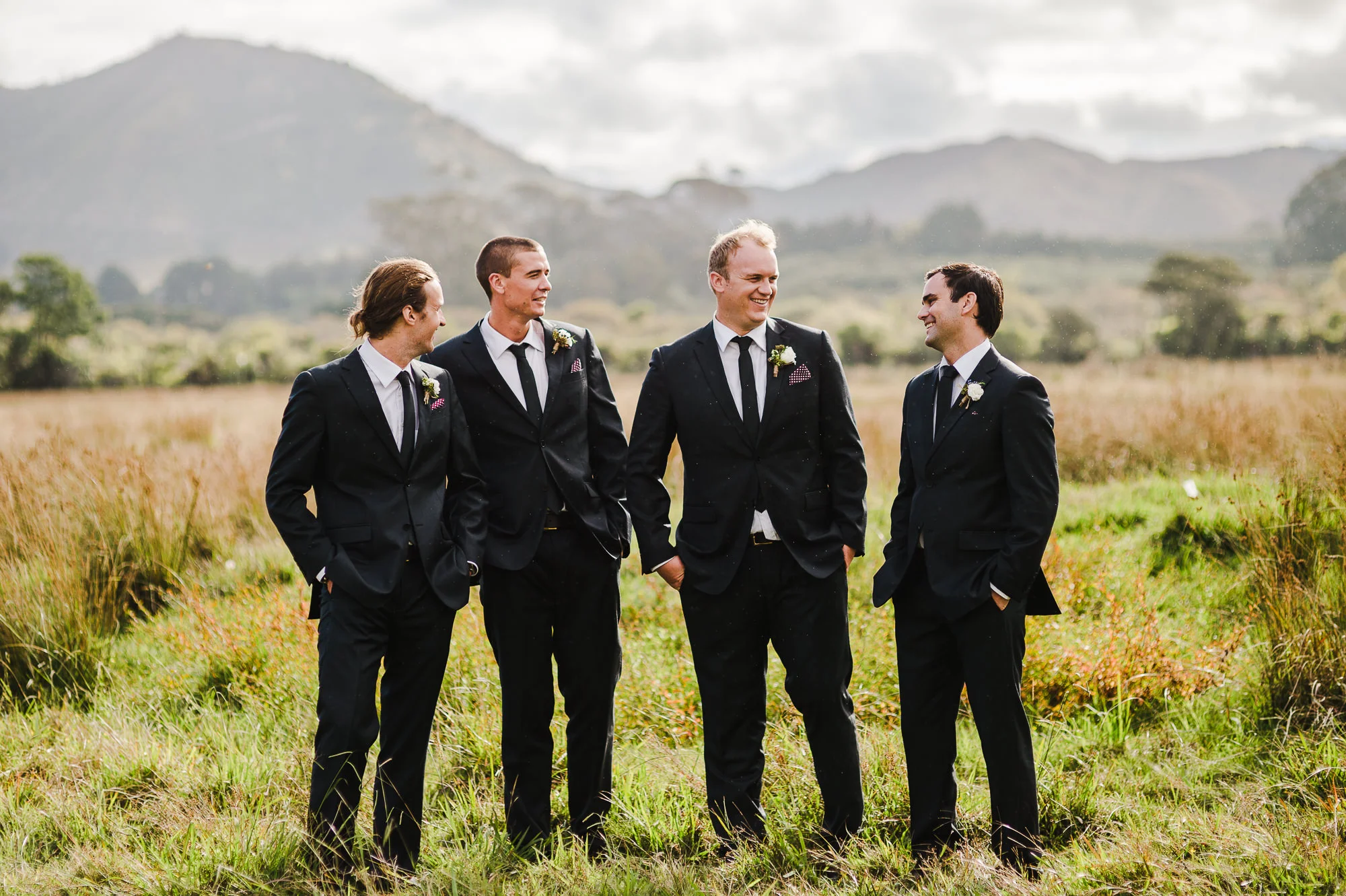 Groomsmen laughing in field.jpg