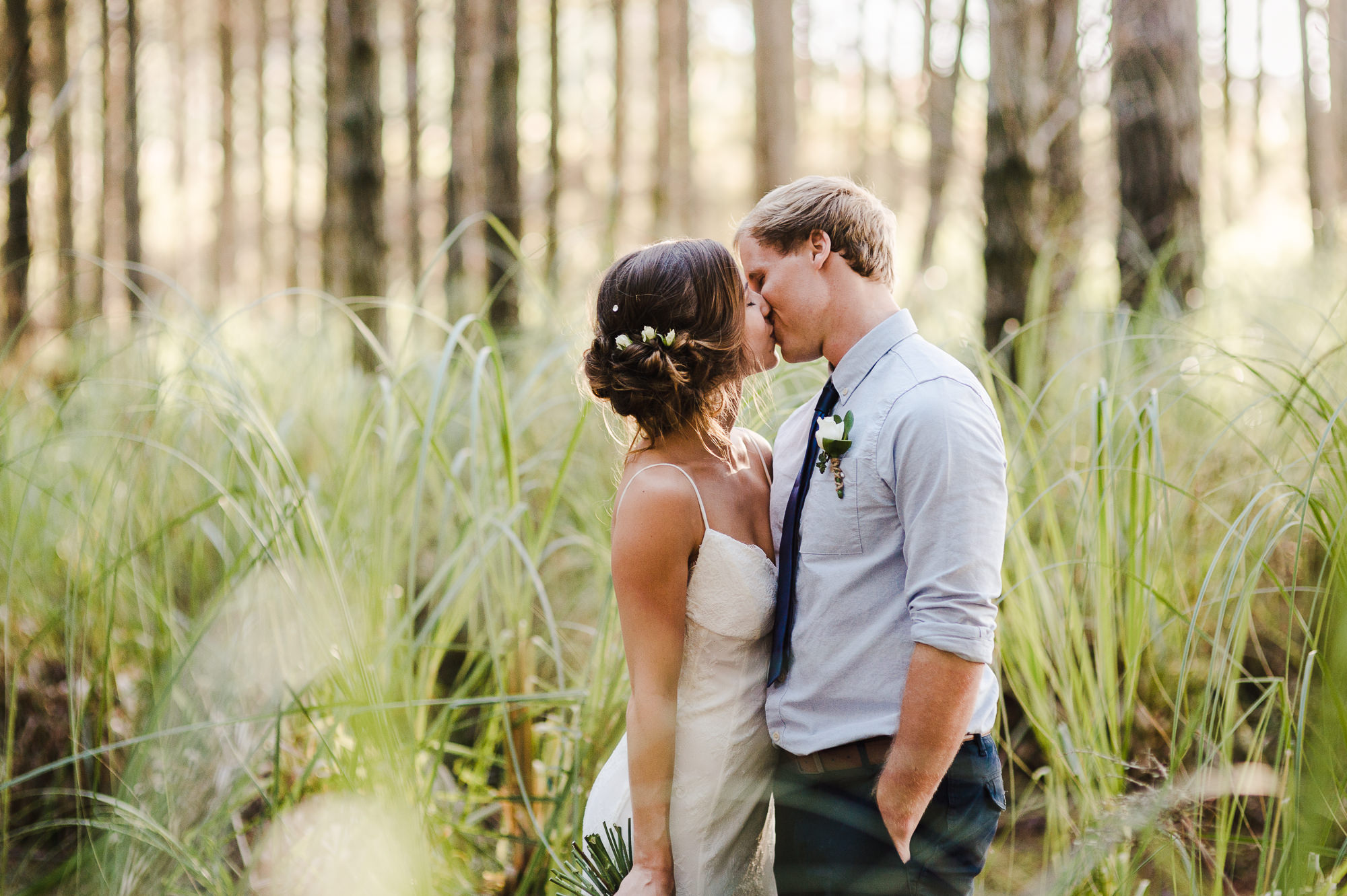 kissing wedding couple in woods.jpg