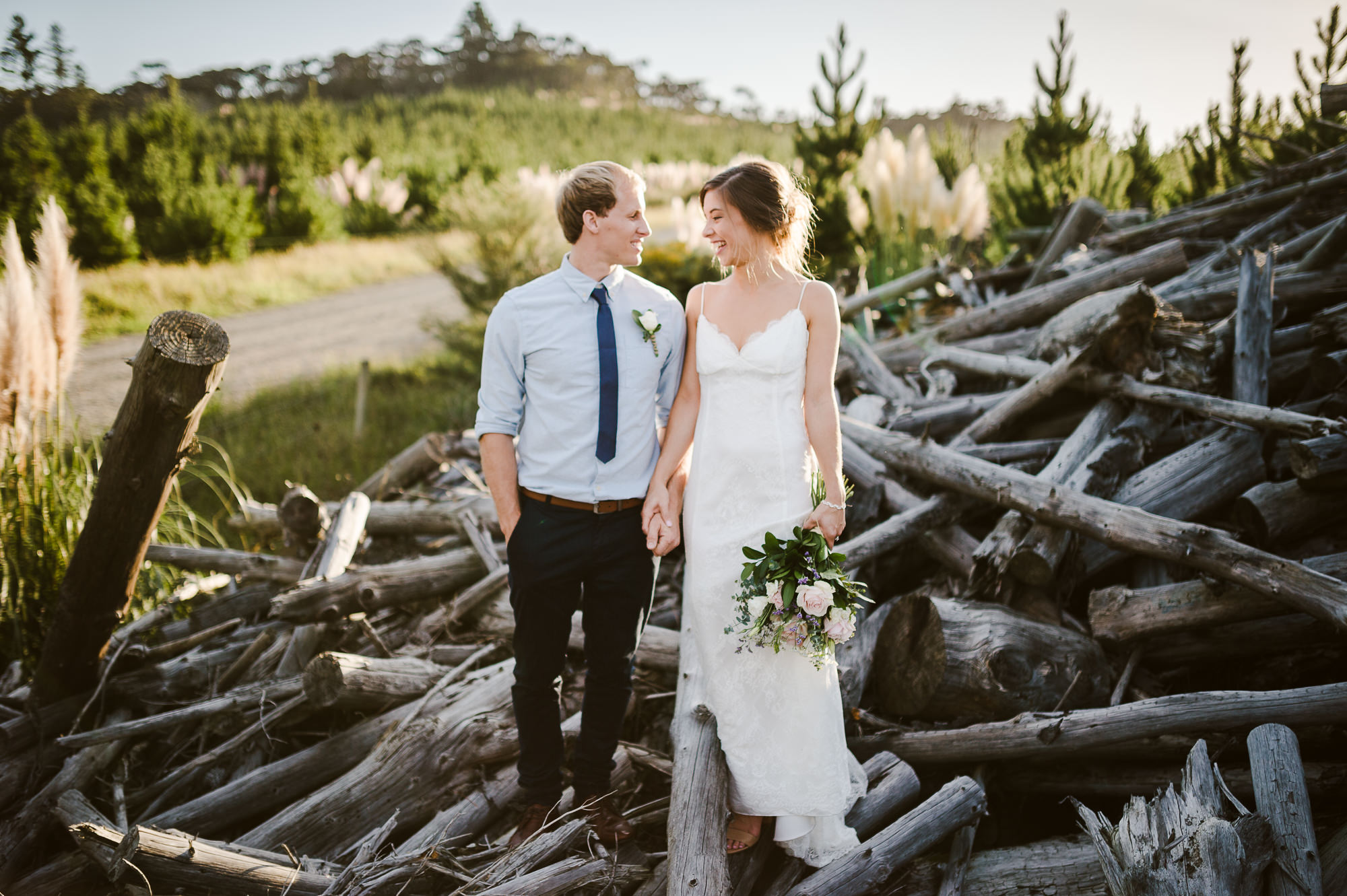 fun hipster couple on pile of logs.jpg