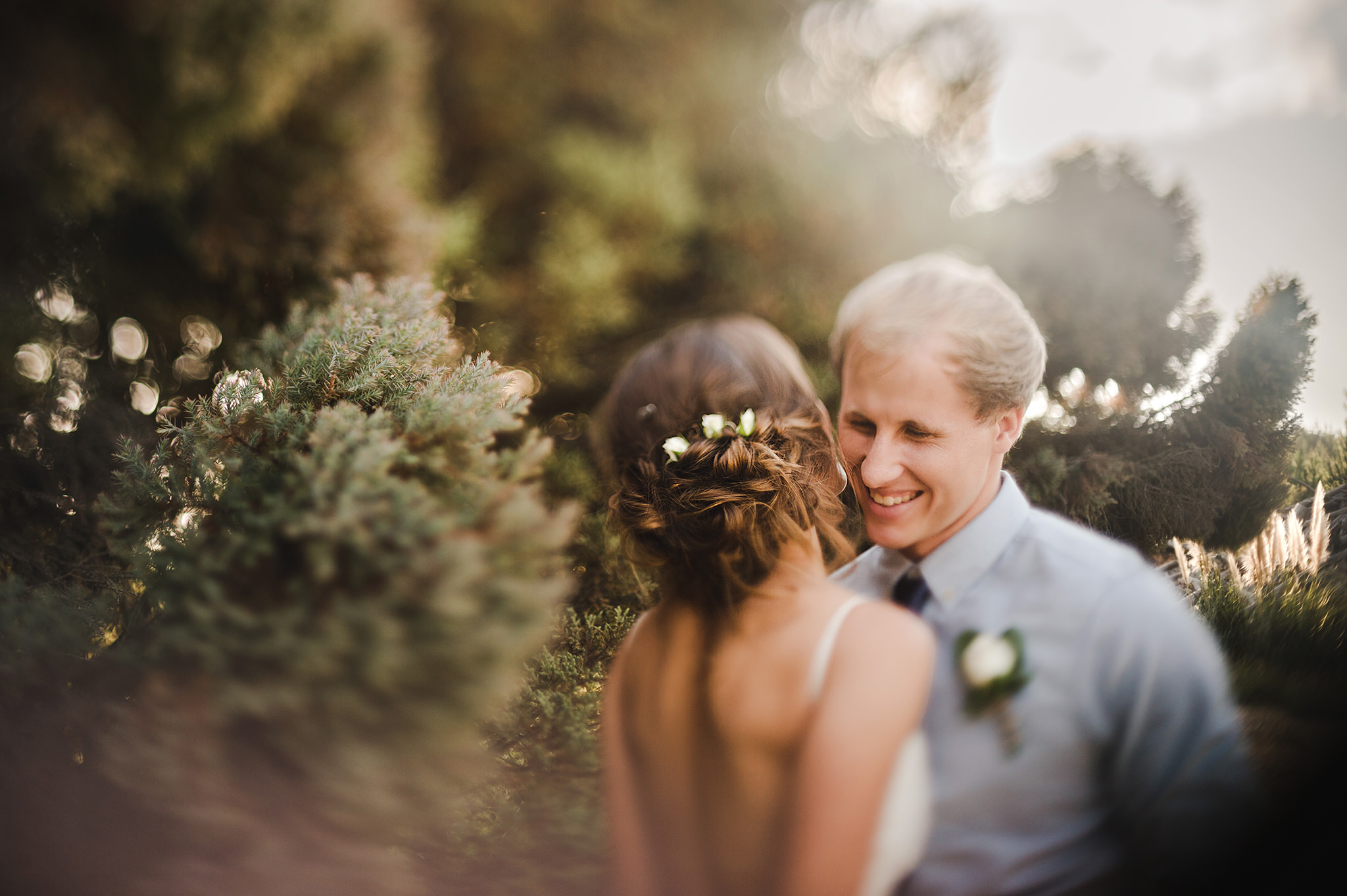 freelensing wedding laughing groom flowers in brides hair.jpg