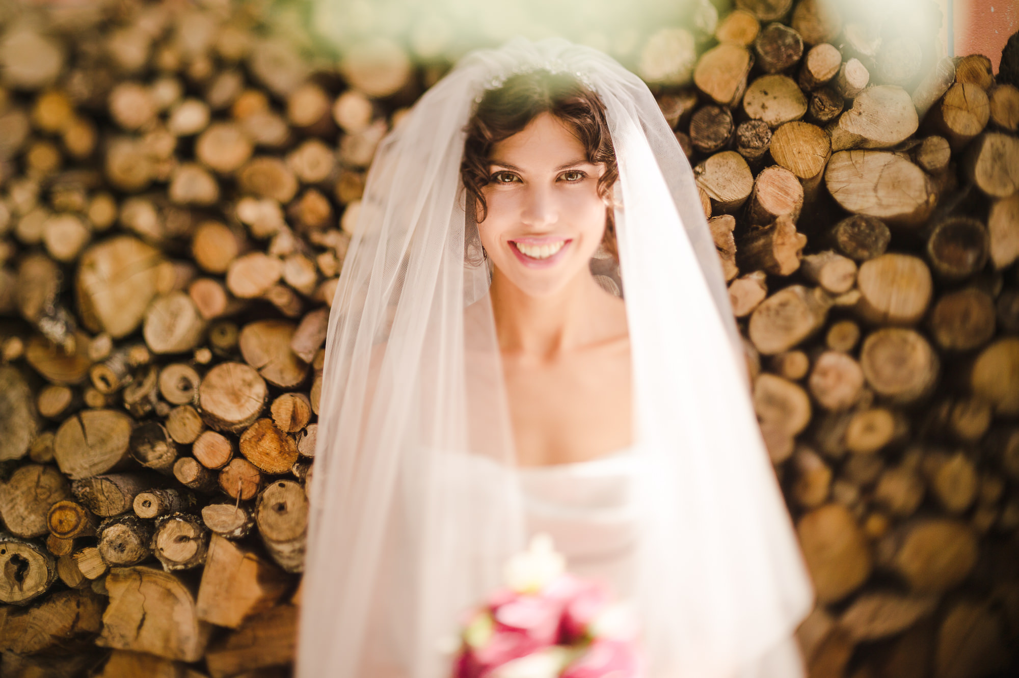 36 freelensed portrait of bride in front of logs auckland wedding.JPG
