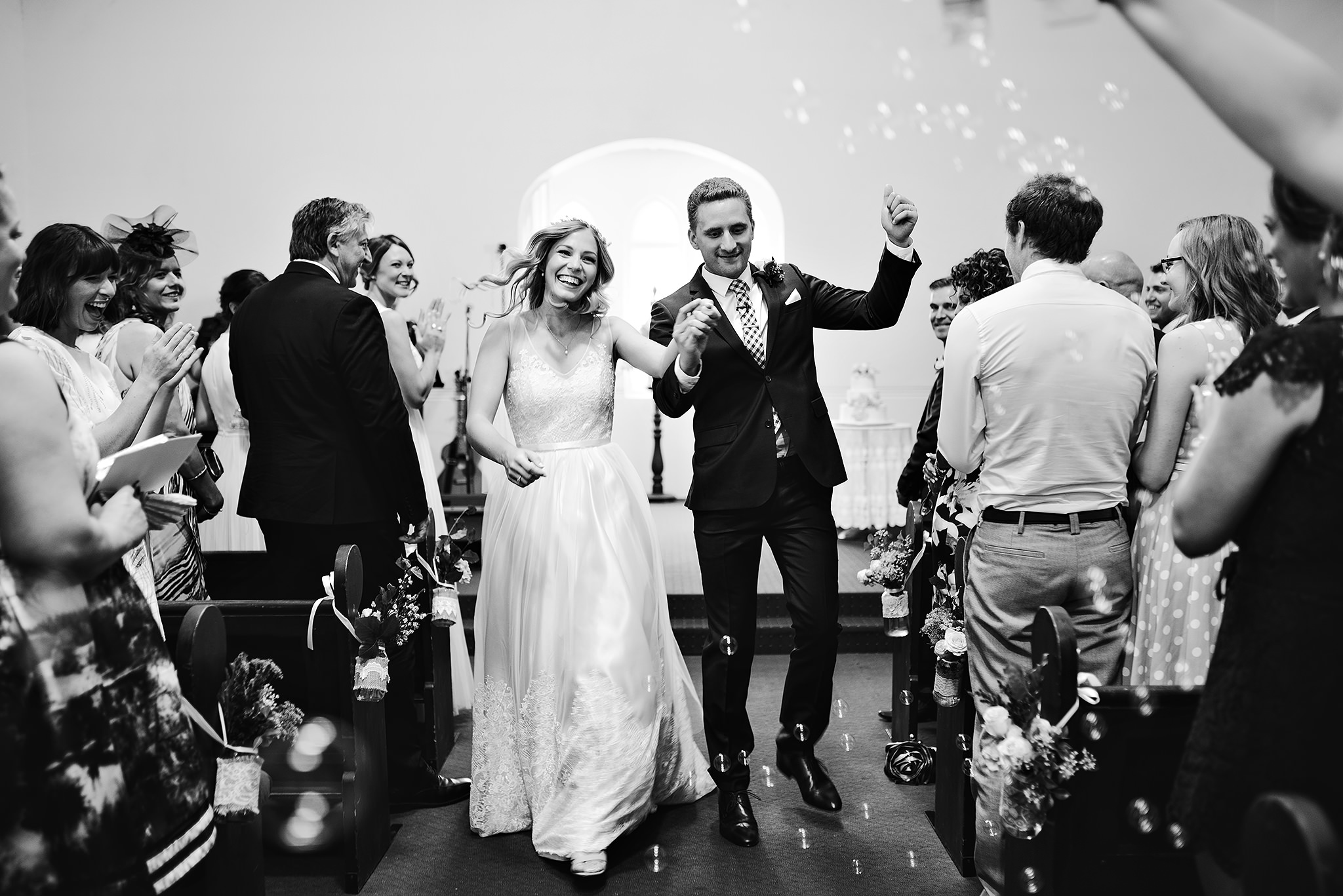 63 church wedding bride and groom walking down aisle with bubbles.JPG