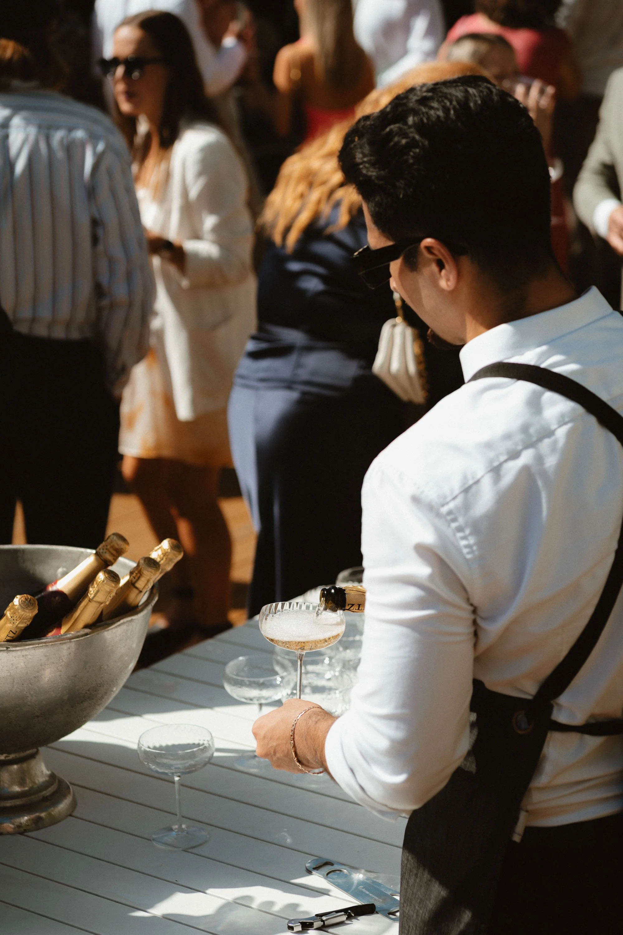Drinks station, bartender pouring a drink for guests