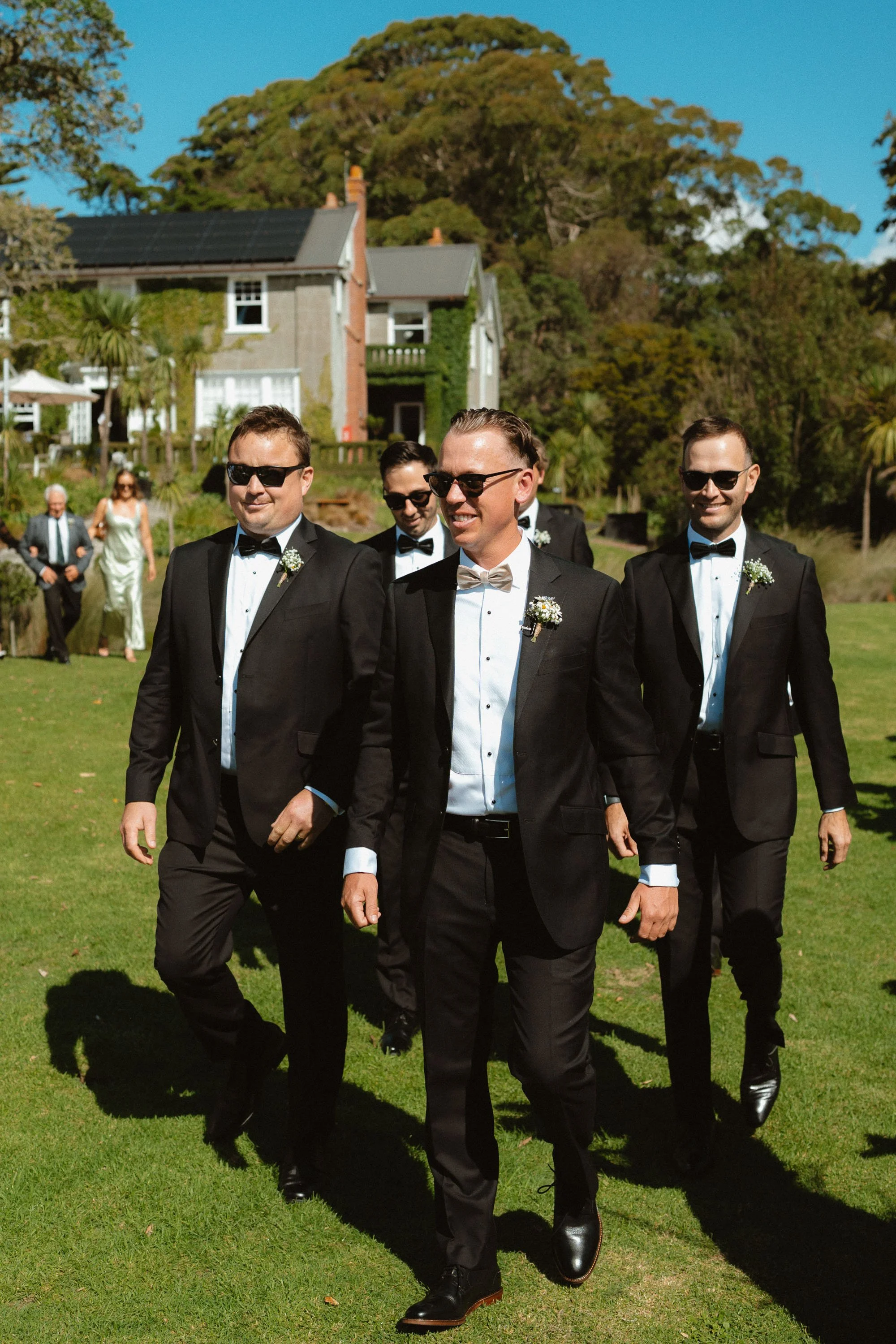 Groomsmen walking down to the ceremony at The McCallum Residence