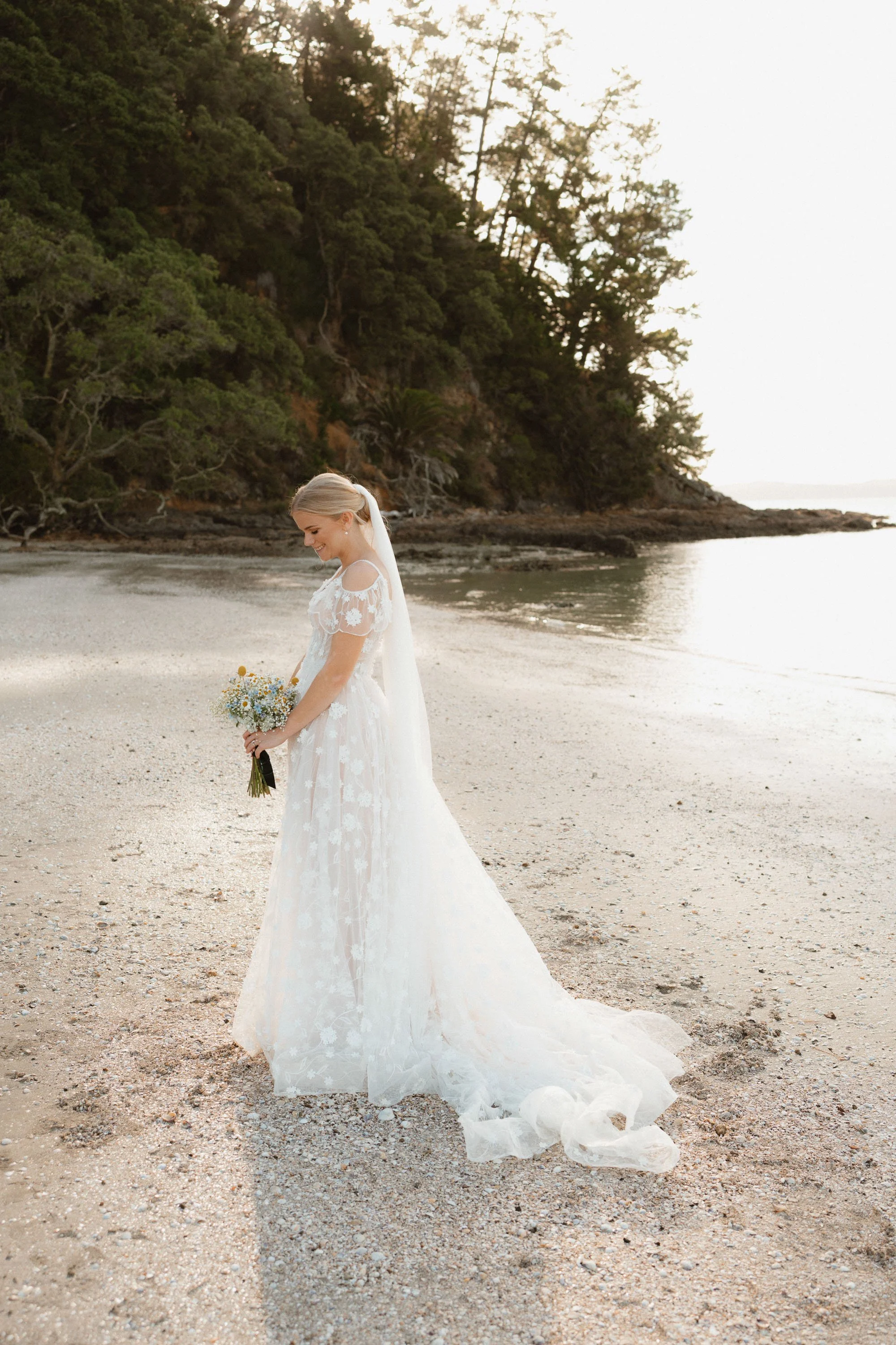 Colour portrait of bride showing full dress at The McCallum Residence beach