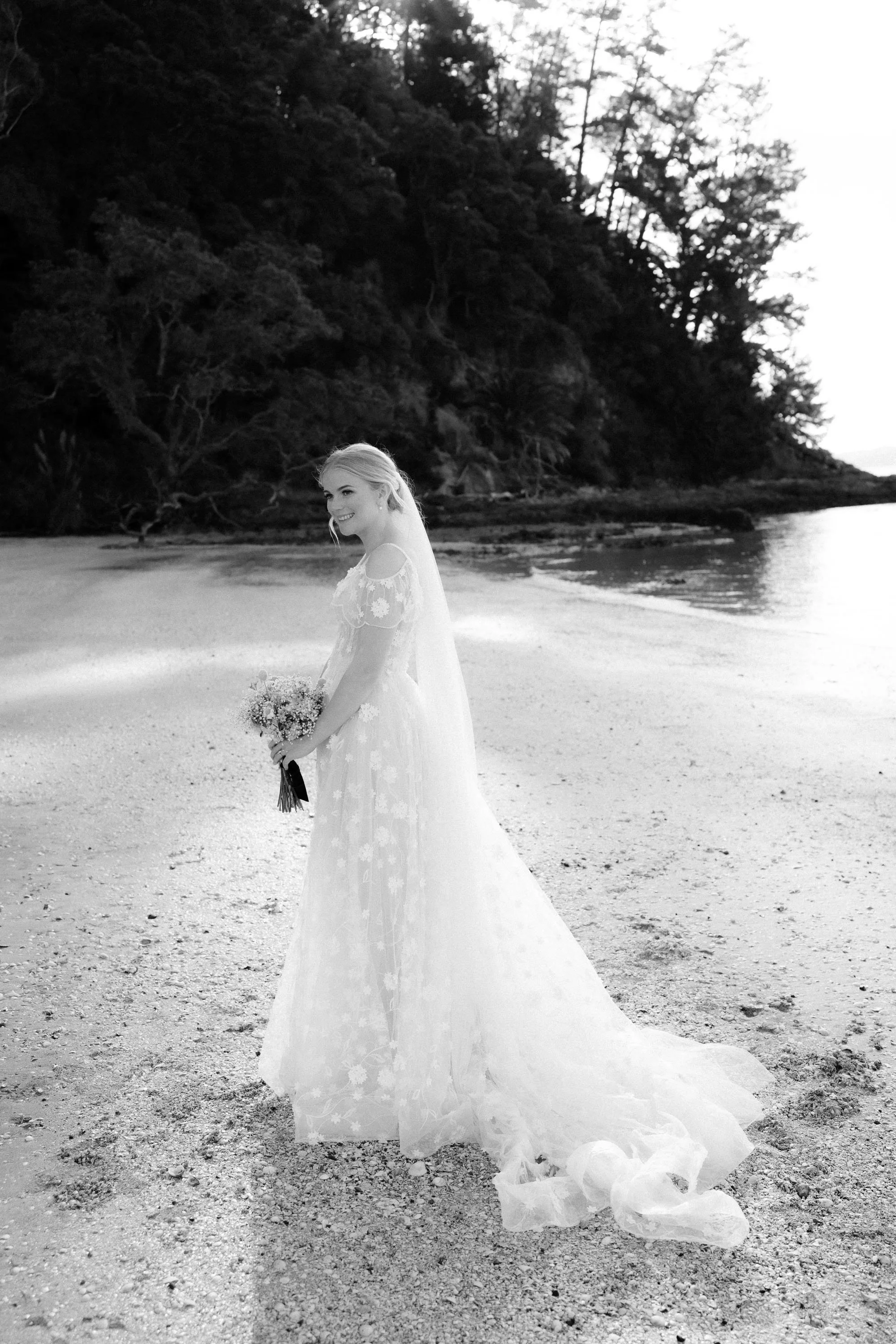 Black and white portrait of bride are standing on beach at The McCallum Residence