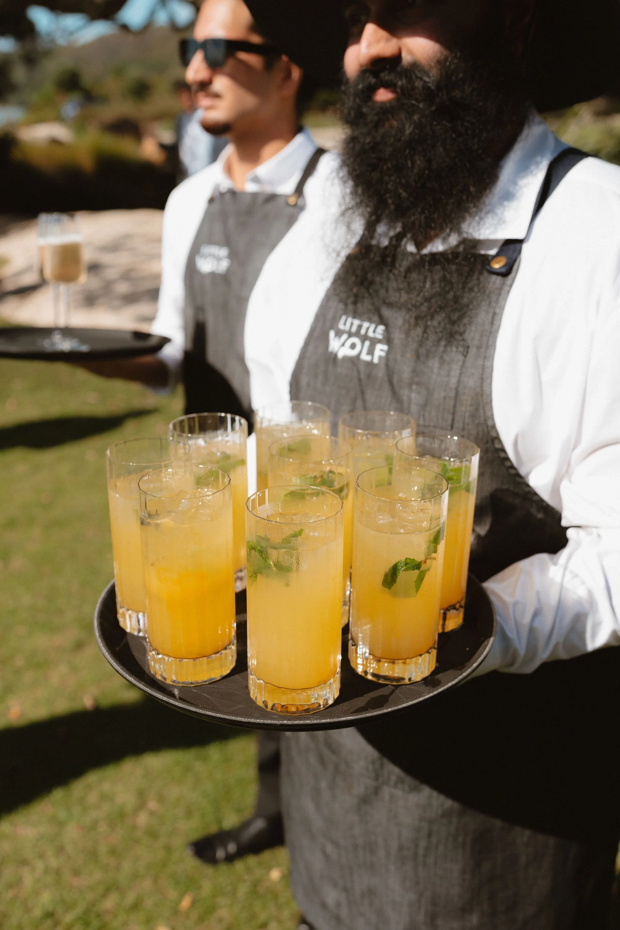 LittleWolf catering uniform and drinks being served