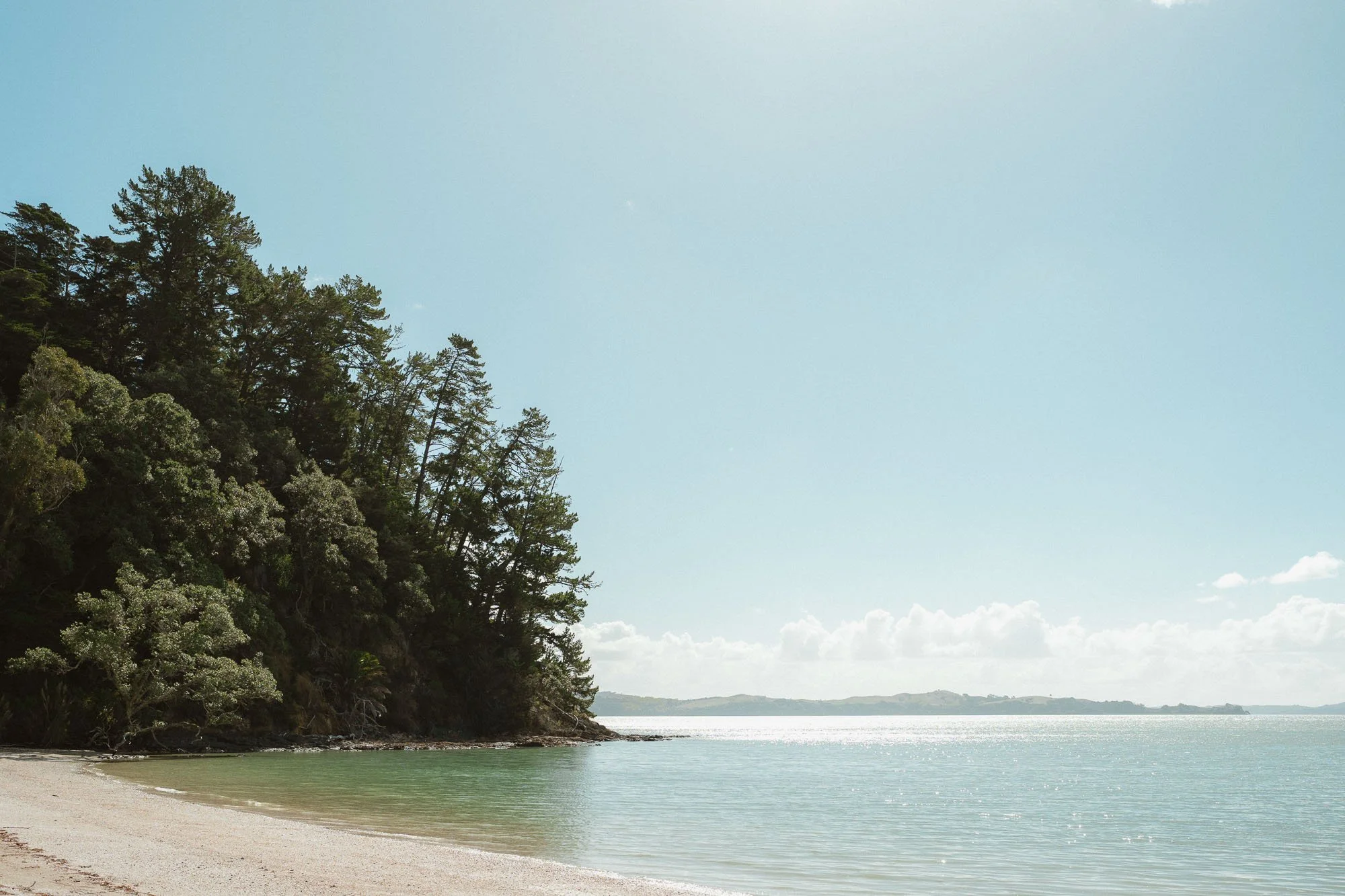 The McCallum Residence private beach on sunny blue sky day