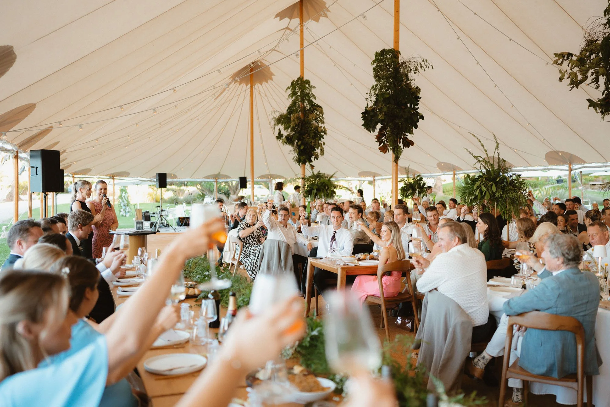 guests cheersing in marquee at The McCallum Residence reception