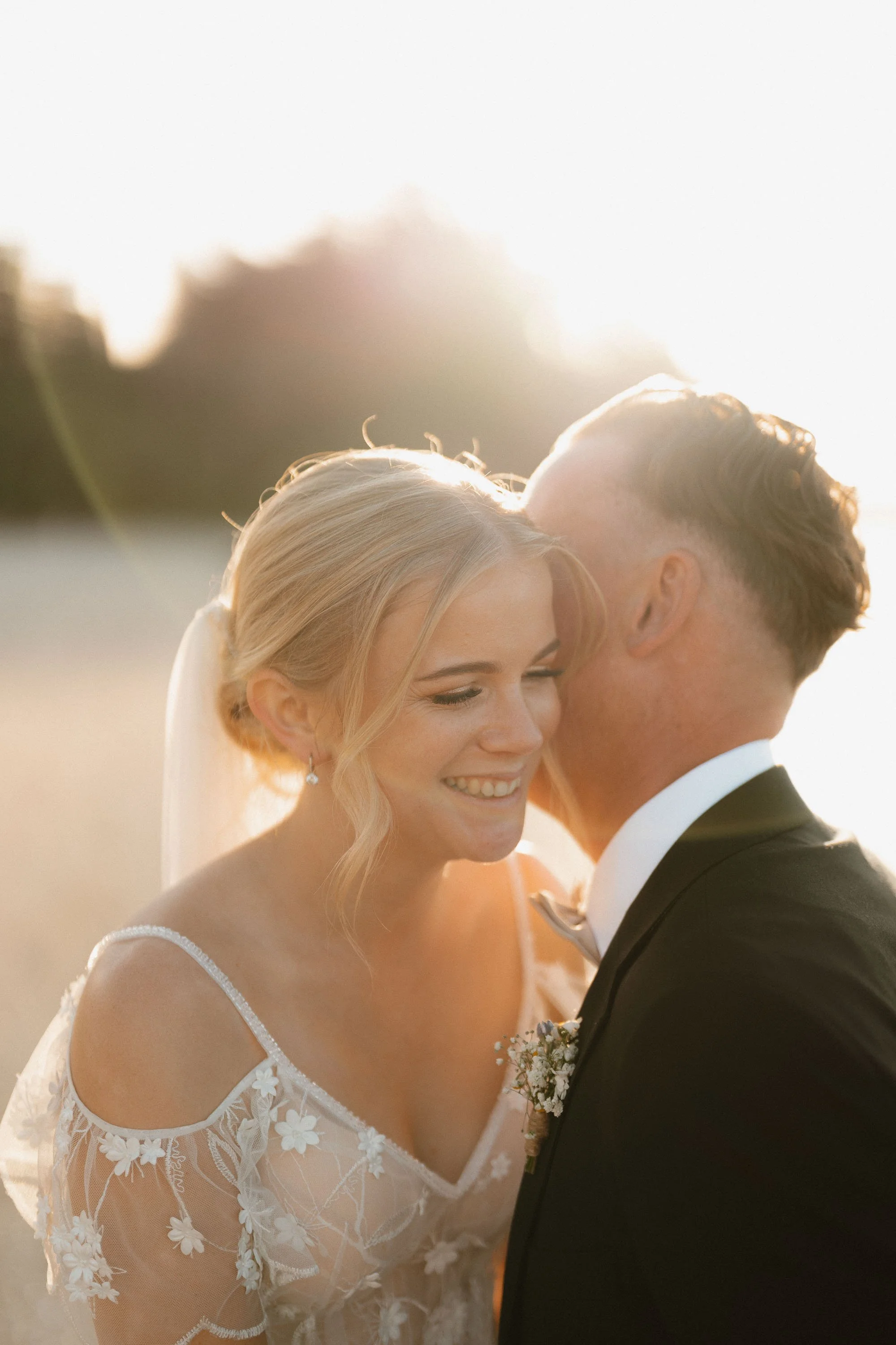 Close up moment of bride smiling with 50mm F1.2 at sunset