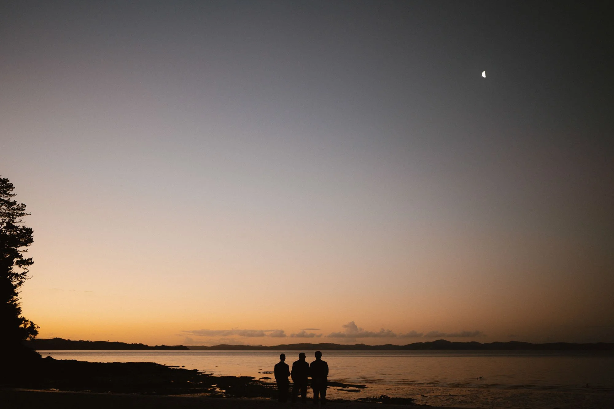 Guests enjoying the beach at dusk at The McCallum Residence