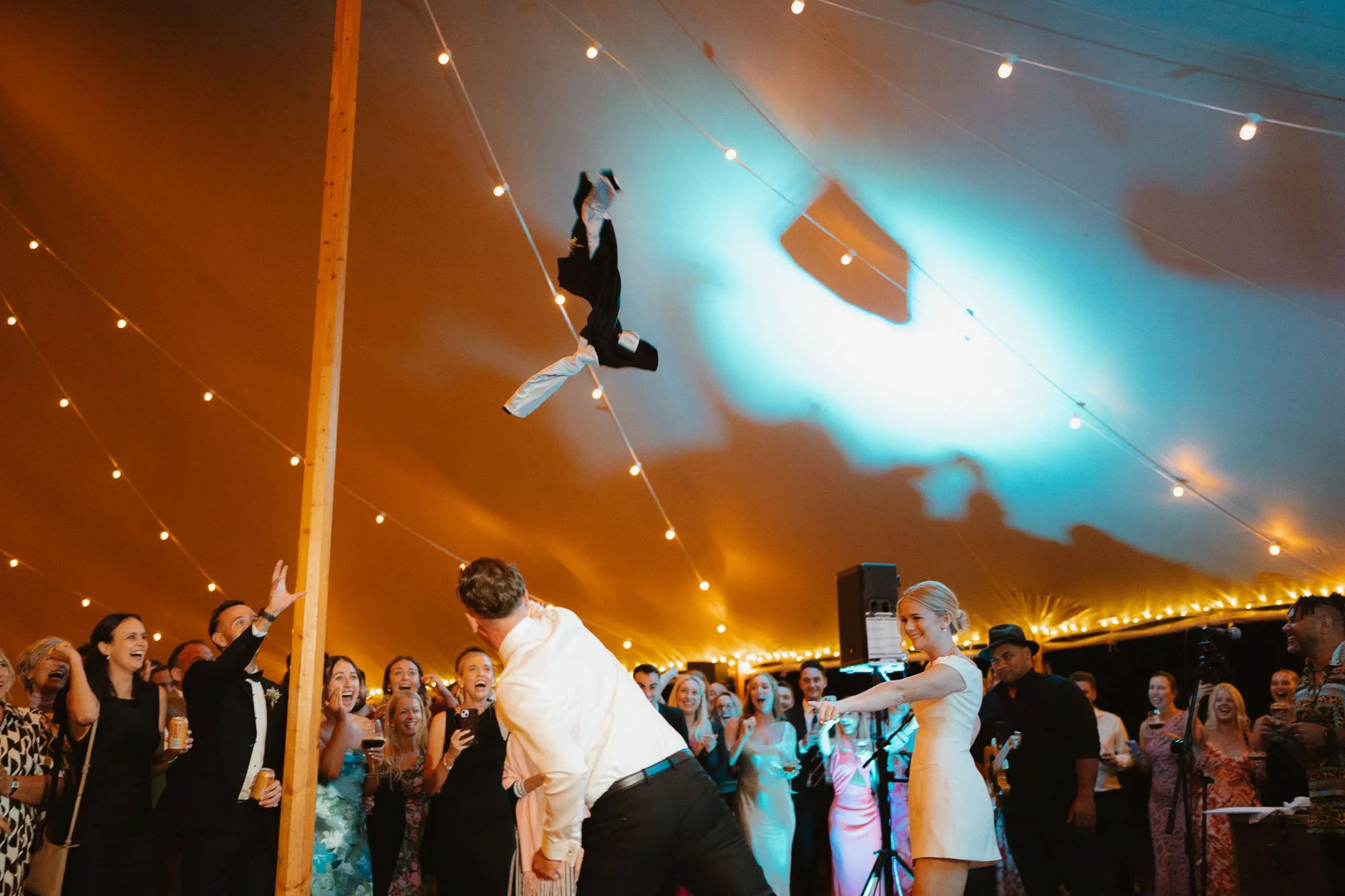 Groom throwing jacket into crowd during first dance