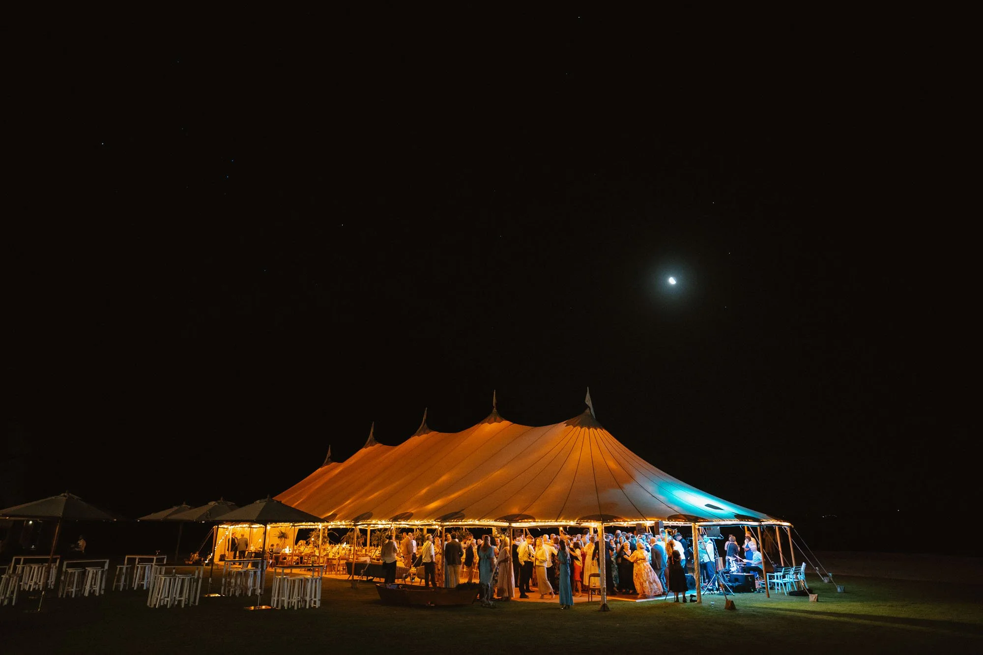 Wide exterior shot of Flagship Events Marquee set up at The McCallum Residence at night while dance floor is going