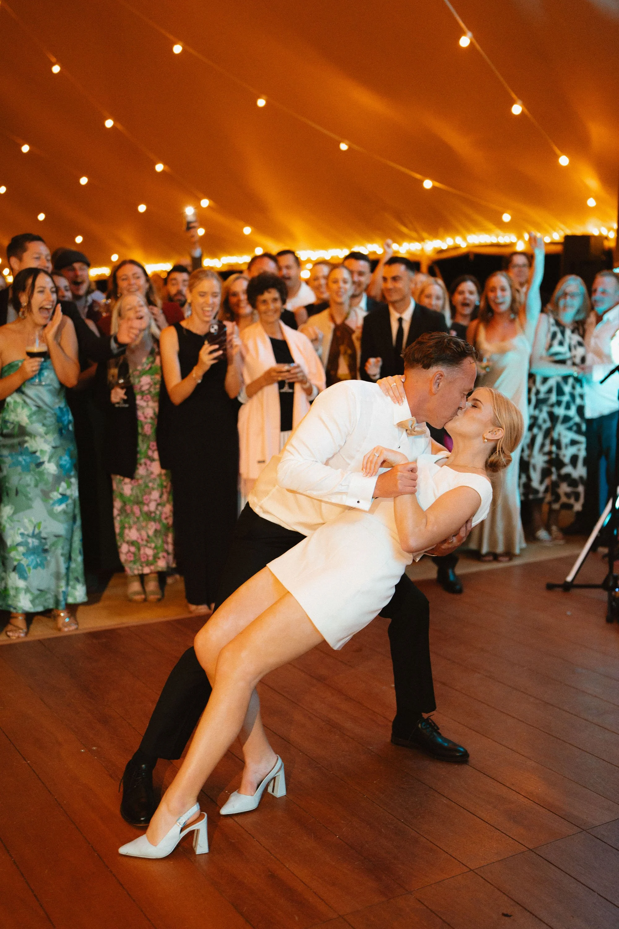 Groom dips bride during first dance