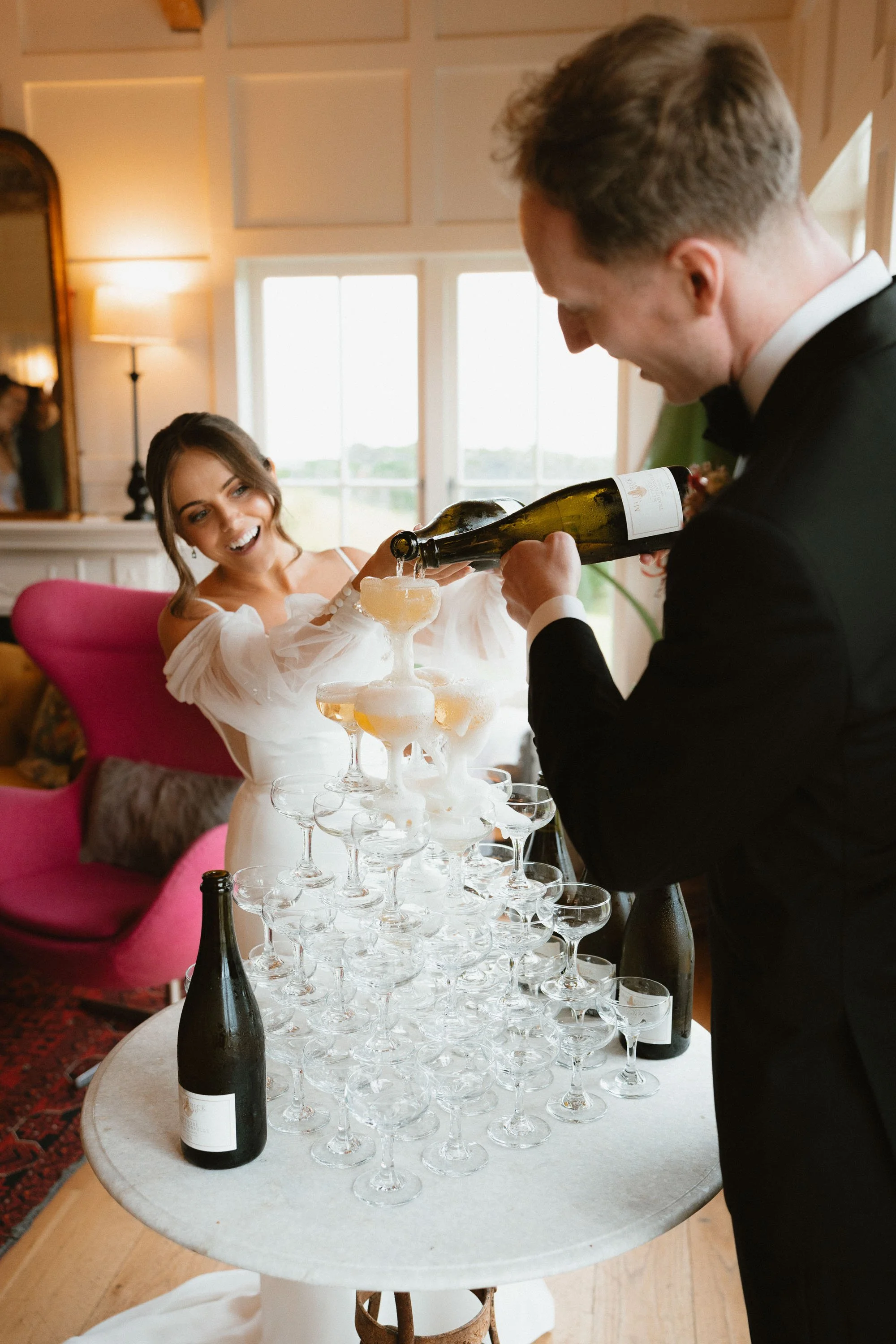 Bride and groom pouring champagne
