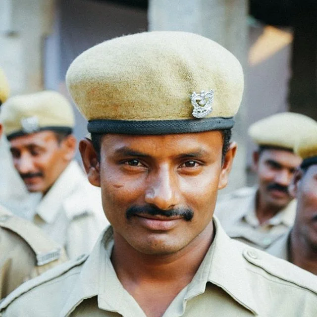 Hangin’ with the police in Hampi. One of many portraits I captured when I somehow found myself walking through a police brigade training session. #onlyinindia #police #beretstyle #smirk #50mm