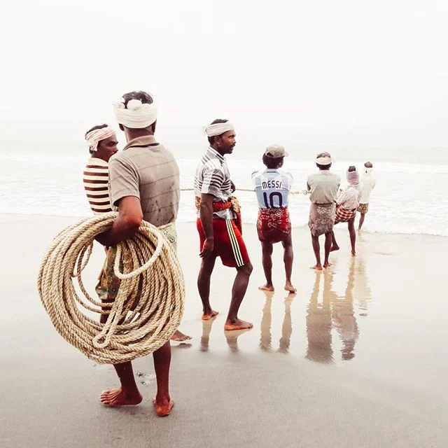 I remember learning how to draw perspective while in elementary school. Seems a lot easier to explain with a photo. Fisherman in Kerela work together to pull in their nets. Perspective at its finest. #india