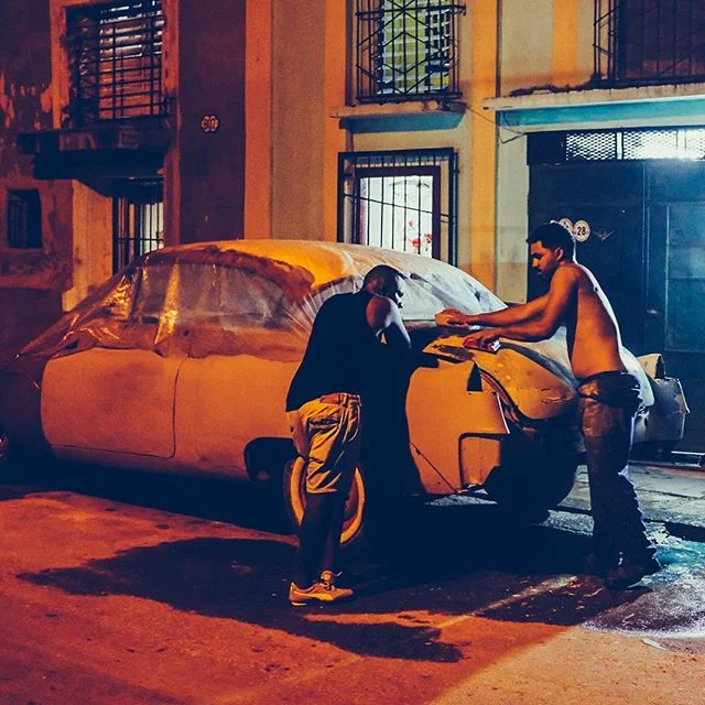 Friends work on restoring a classic car under the amber streetlights of Havana’s seaside district. Cuba is officially my new back yard. Looking forward to capturing more of this amazing country. #fujix100f