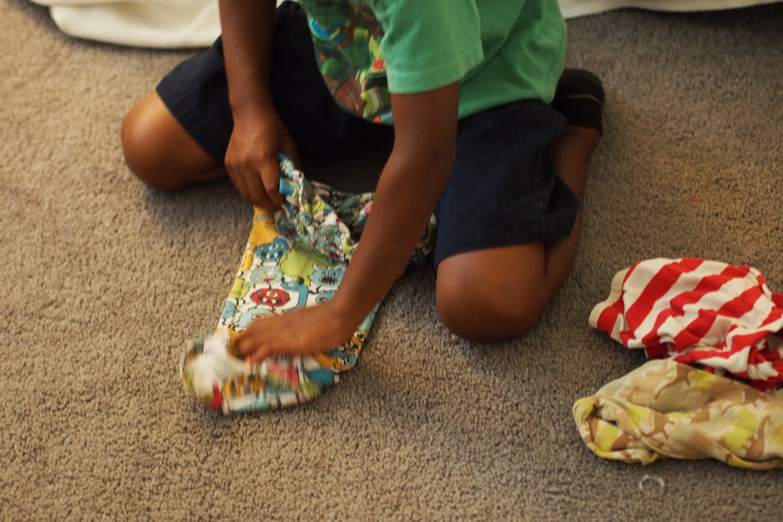 child folding clothing