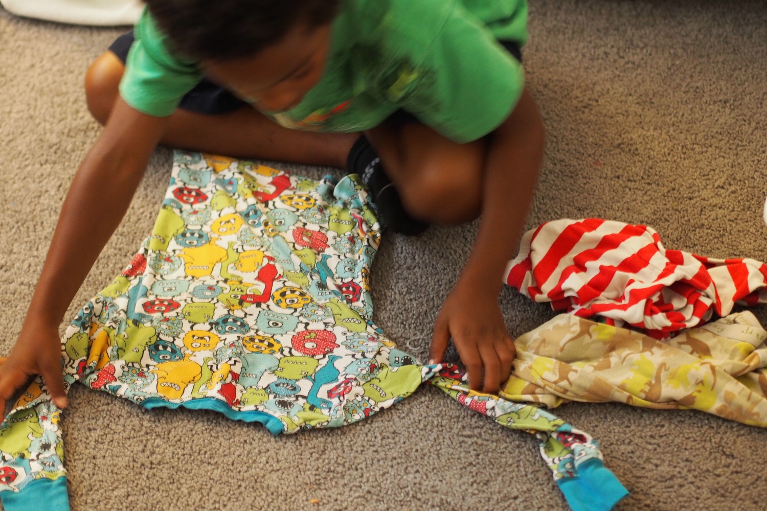 child folds clothes 