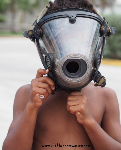 boy wears fireman mask