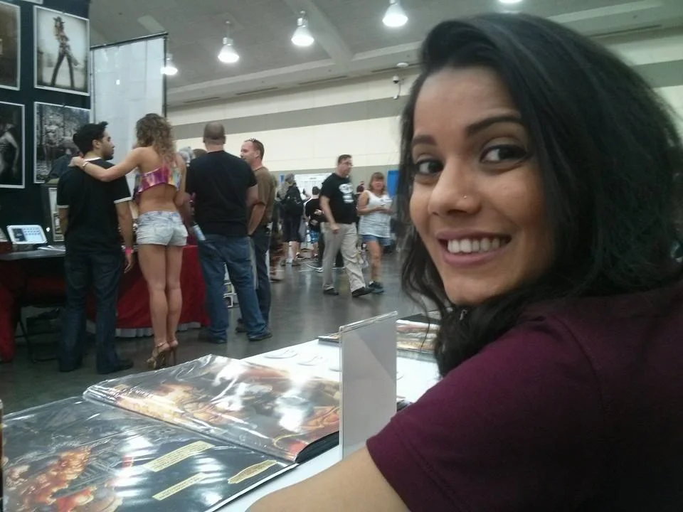 Sarah Syed showing off some pages from Zindan