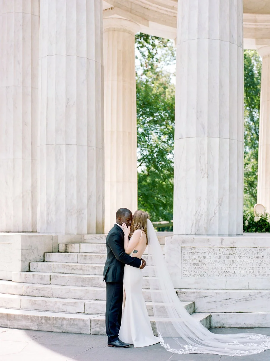 Bride and groom during intimate wedding ceremony at DC War Memorial on the National Mall in Washington DC.