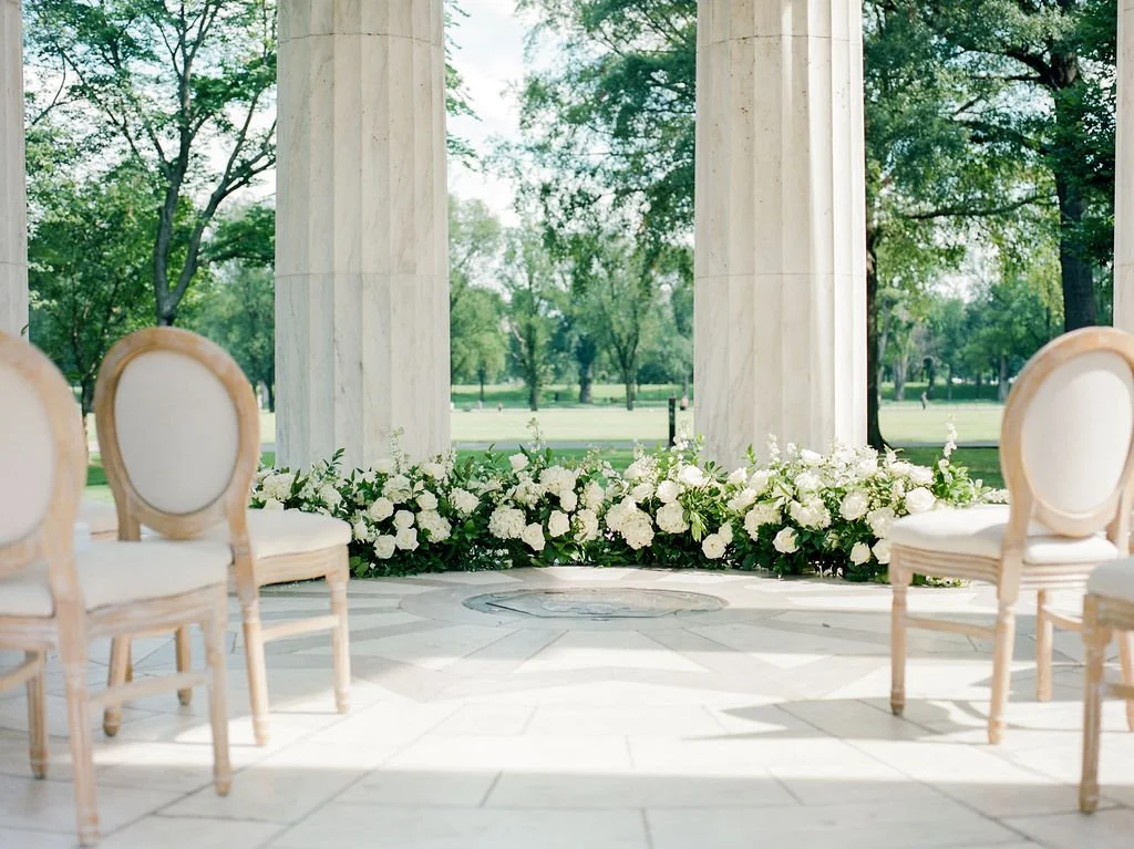 Bride and groom during intimate wedding ceremony at DC War Memorial on the National Mall in Washington DC.