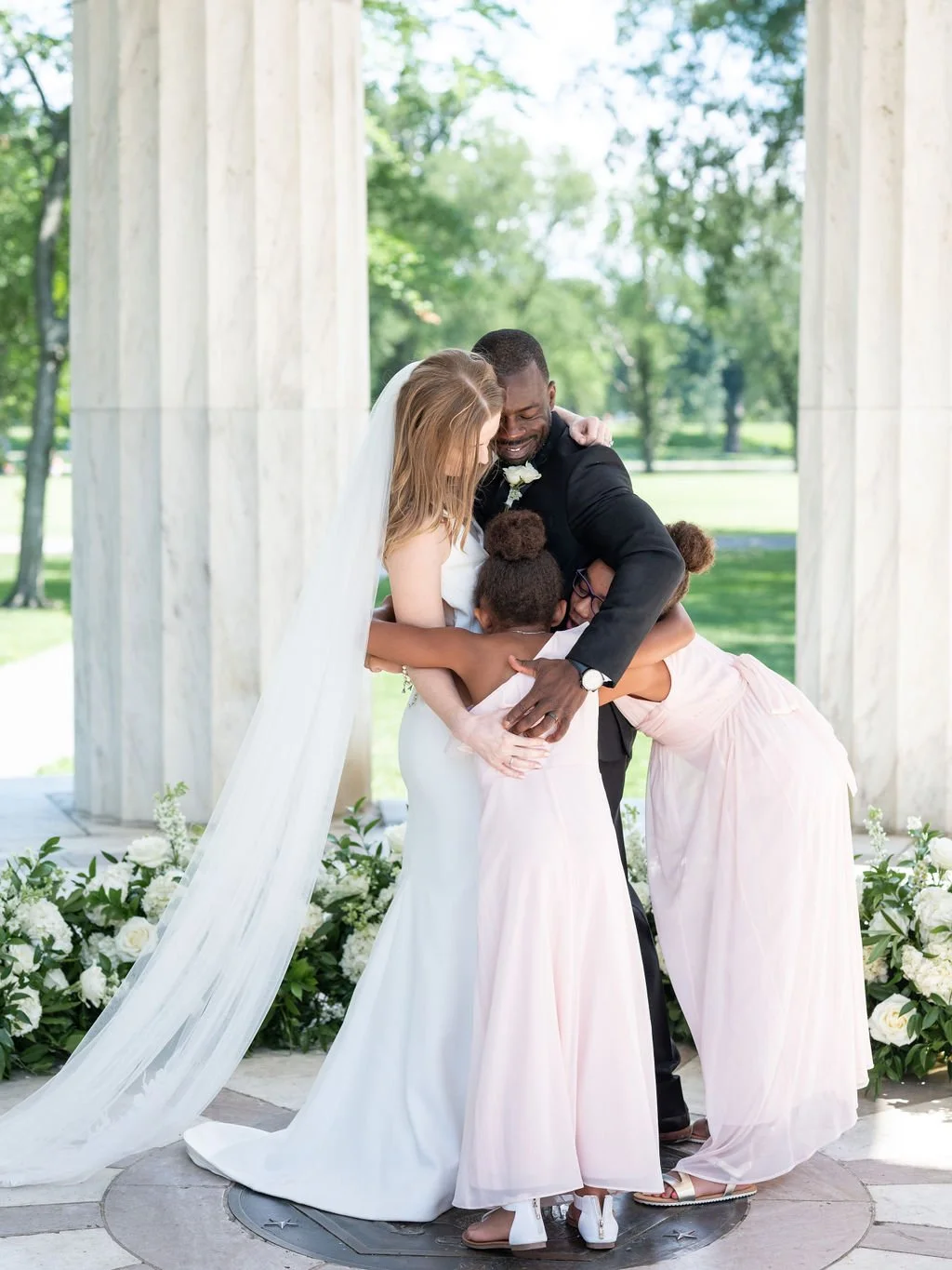 Bride and groom during intimate wedding ceremony at DC War Memorial on the National Mall in Washington DC.
