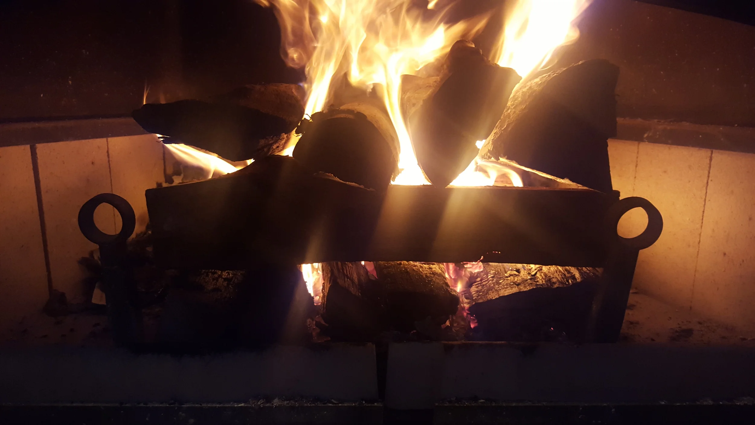 Firewood added in similar cob formation on top of embers from kindle fire