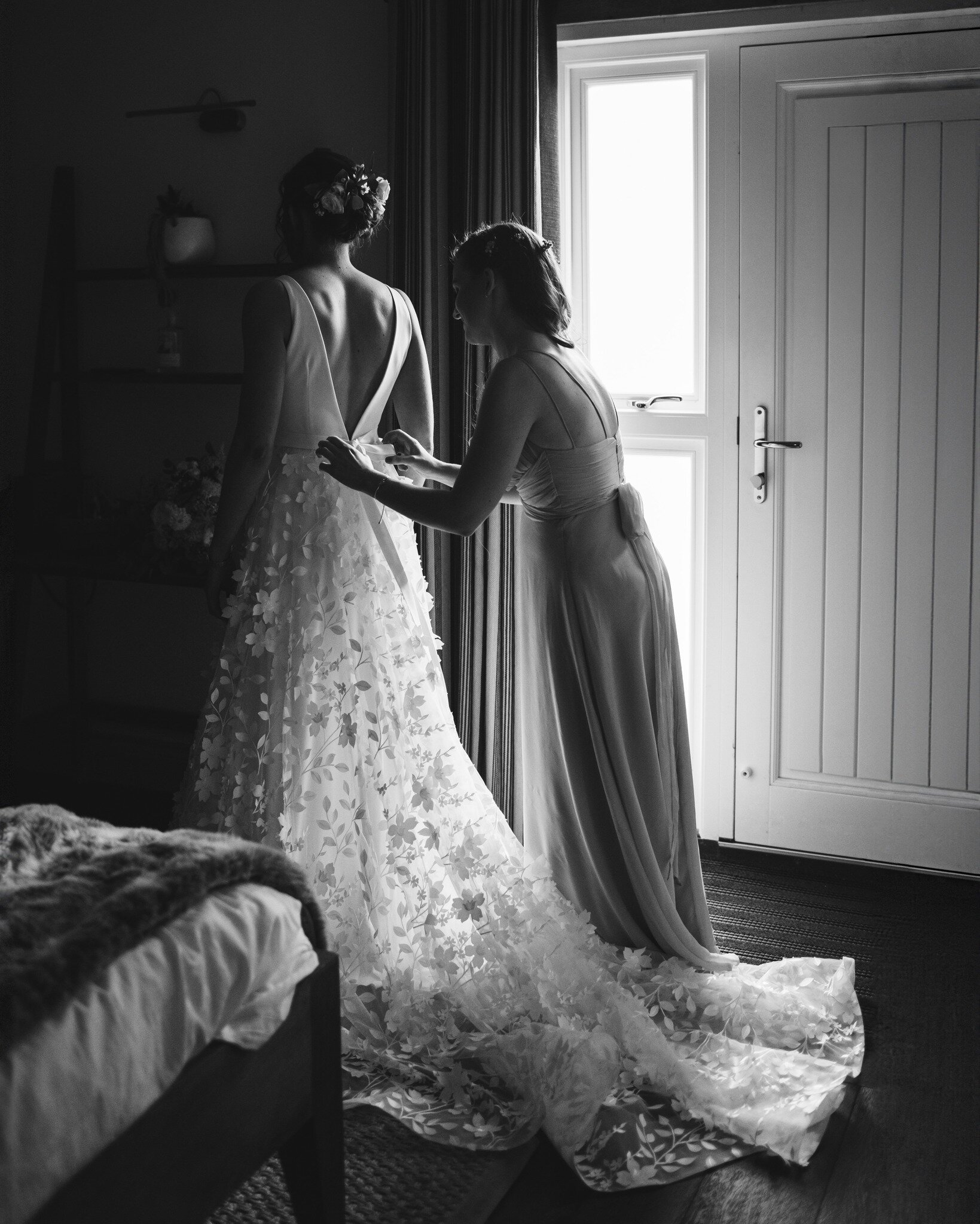 I knew this photo was always going to be black and white, before I even hit the shutter button! I love how the window light perfectly picked up the flowers cascading down Alicia's dress.

Reception venue: @englishheritage Wrest Park
Dress: @houseofsa