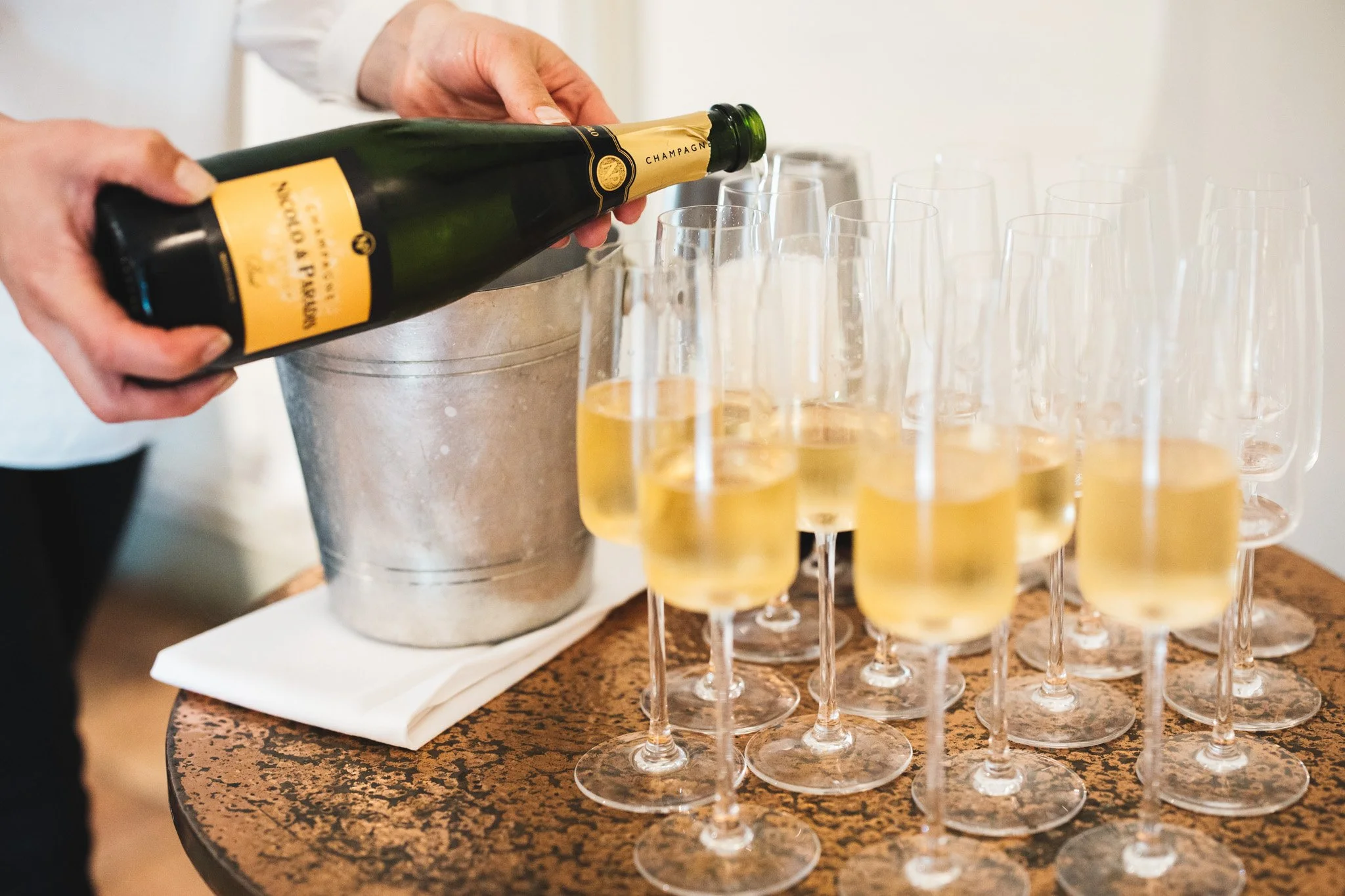 Champagne is poured ahead of the speeches at a micro wedding.