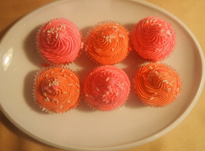 Pink velvet cupcakes decorated in different shades of pink for Breast Cancer Awareness Month.
