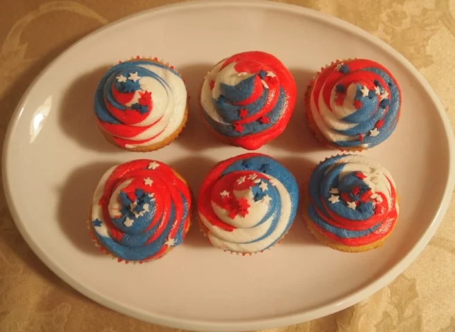 New vanilla cupcakes but with swirled red, white, and blue icing.