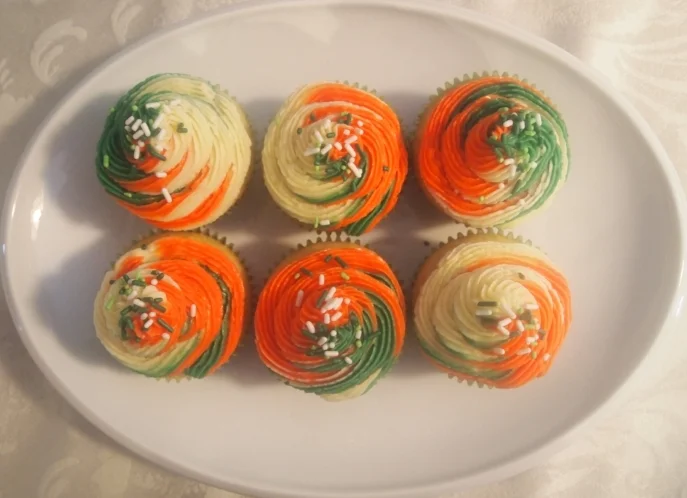 New vanilla cupcakes but with swirled icing in the colors of the Irish flag.